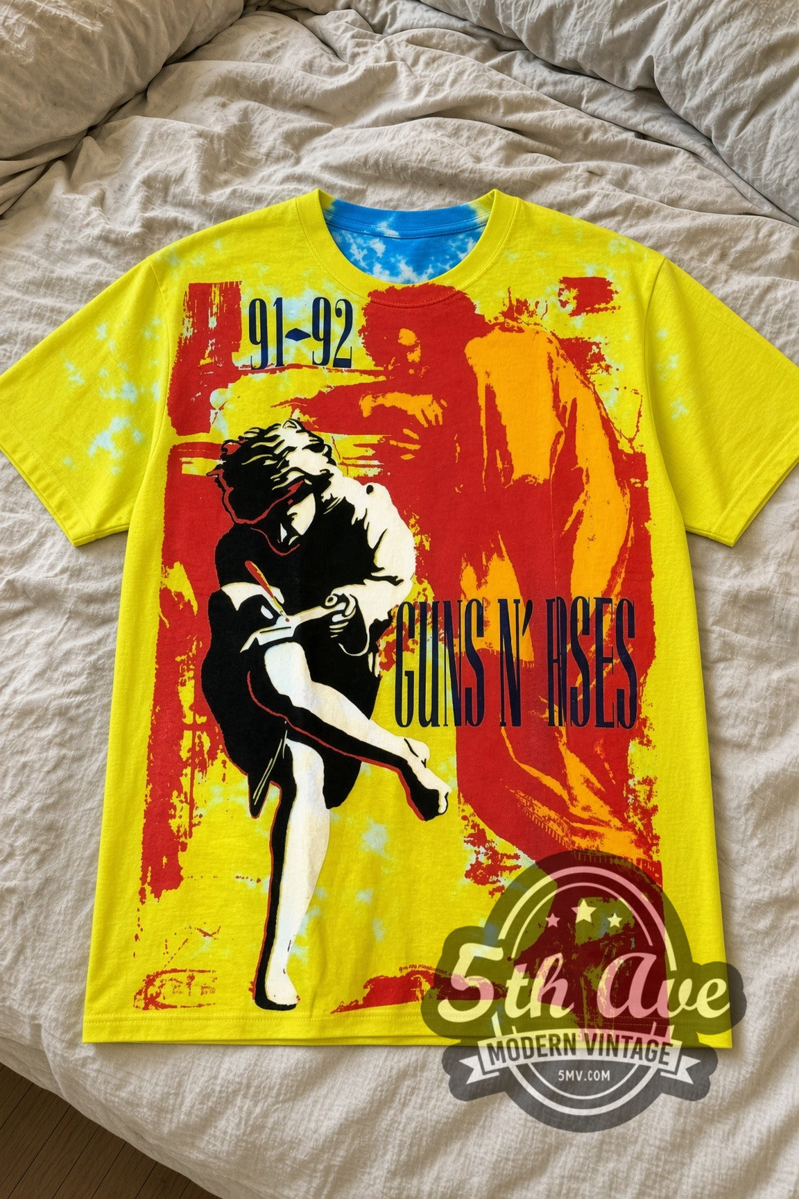 Guns N' Roses Use Your Illusion Tour yellow all-over-print band tee laid flat on a linen bed