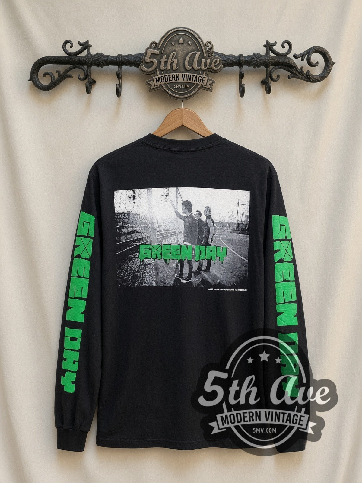 Green Day Kneeling Singer vintage band long sleeve t-shirt, back view on a display rack
