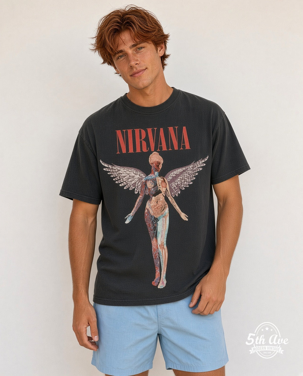 Model wearing the Nirvana In Utero Red Block Logo Color Anatomical Angel vintage band t-shirt in black