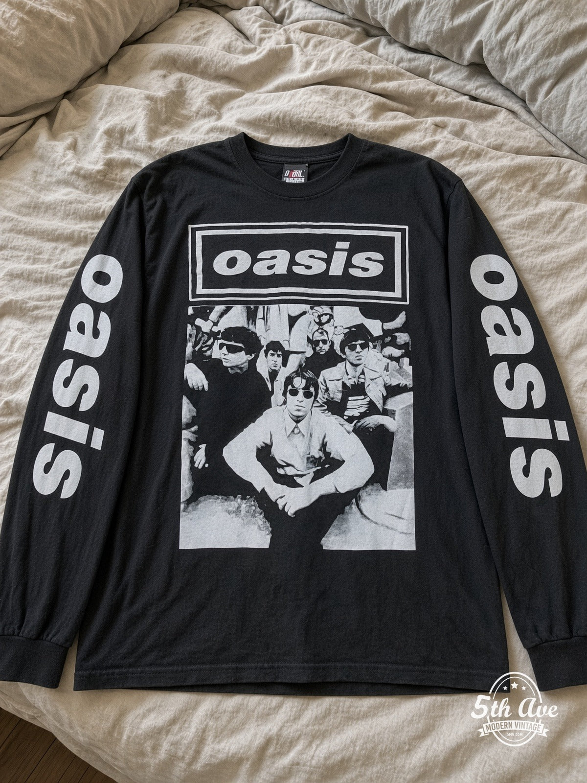 ETS LS 11 Oasis Band Photo long sleeve vintage tee laid on a bed