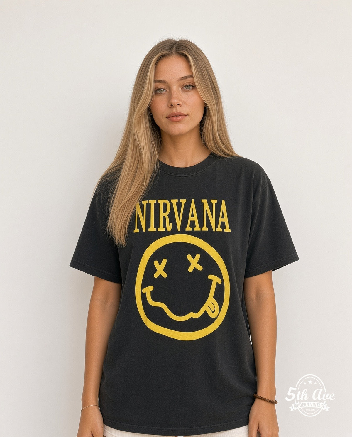 Model wearing the Nirvana Classic Yellow Smiley Face Logo vintage band t-shirt