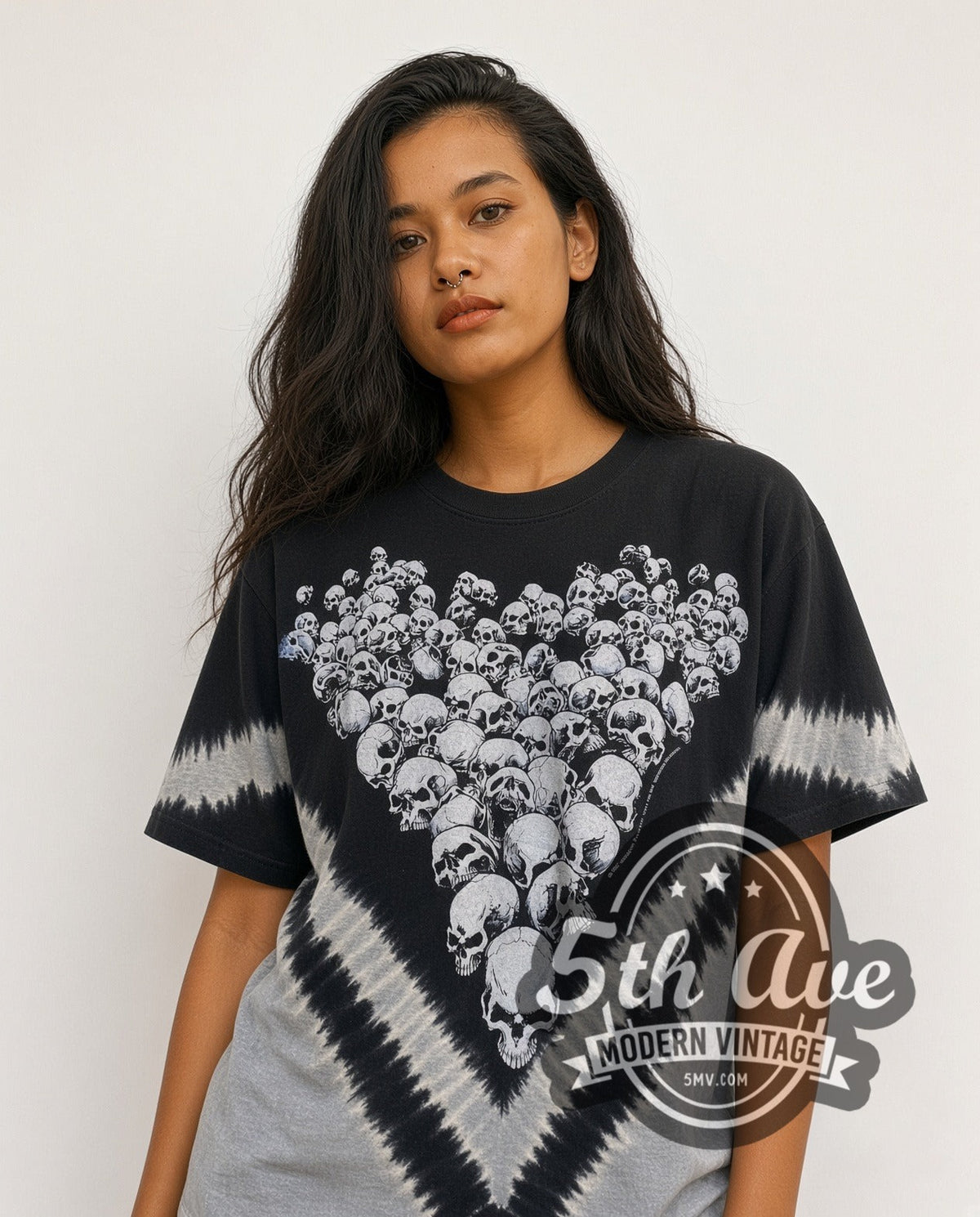 Model wearing the Boneyard Skulls Tie-Dye Skull Pile all-over-print vintage graphic tee