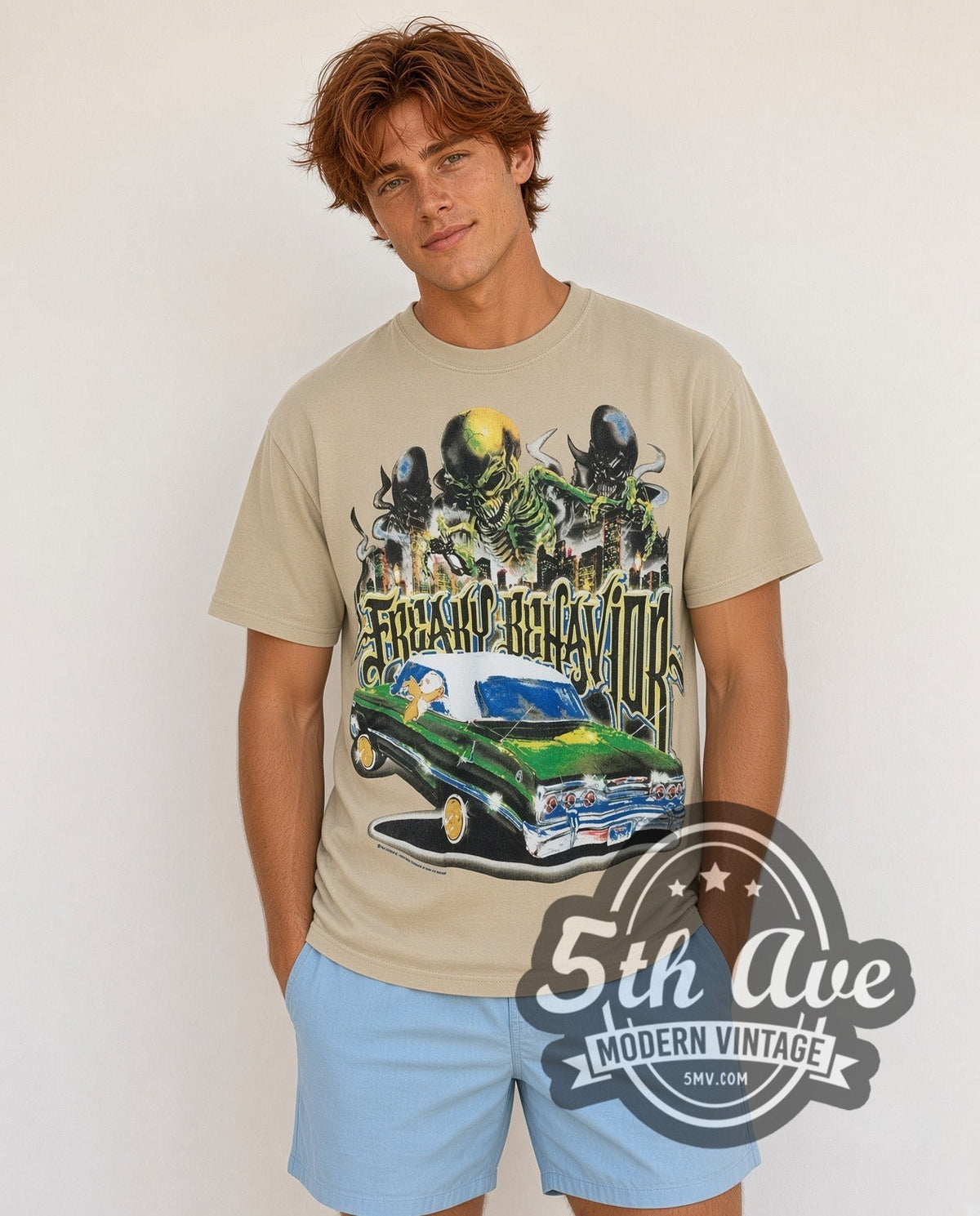 Model wearing the Rollin Hard Freaky Behavior Lowrider vintage graphic tee in sand
