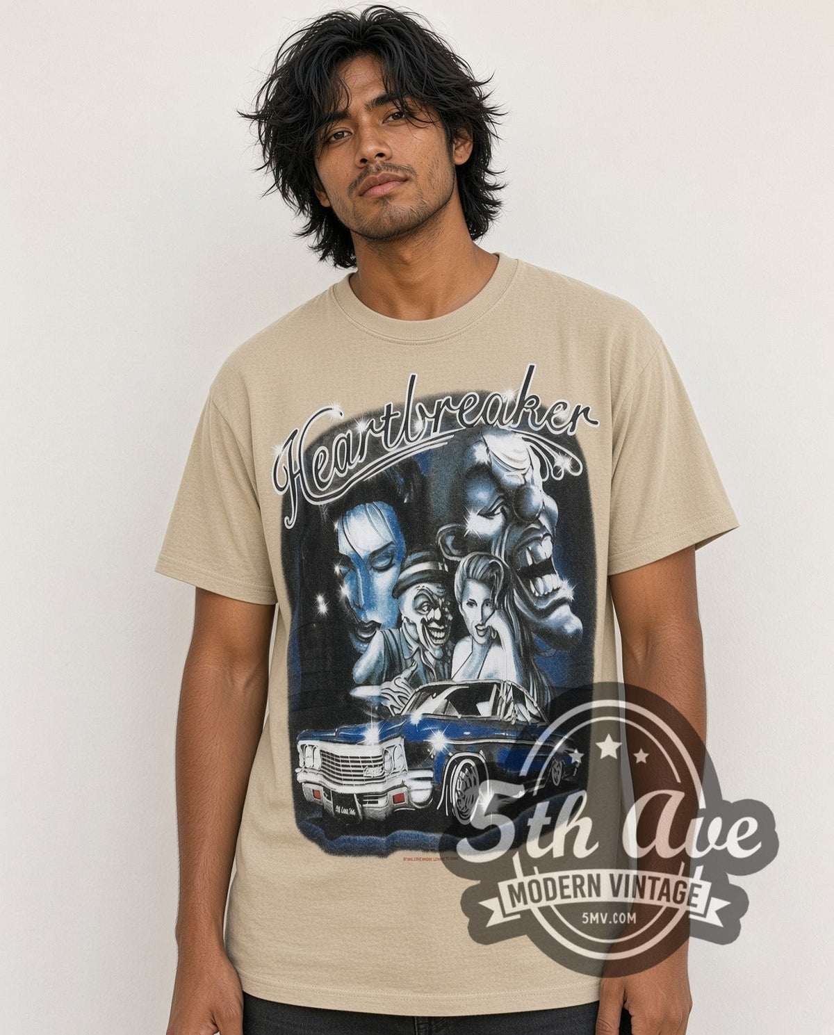 Model wearing the Rollin Hard Heartbreaker Lowrider vintage graphic tee in sand