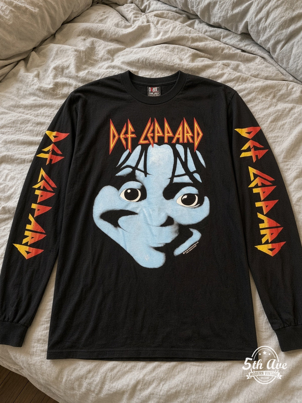 ETS LS 18 Def Leppard Blue Face long sleeve vintage tee laid on a bed