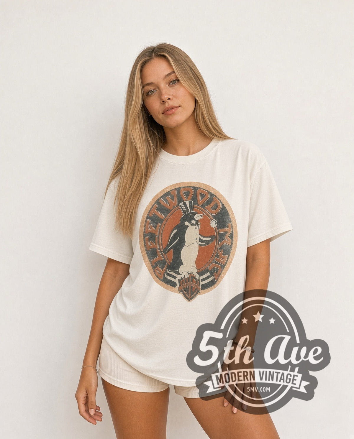 Model wearing the Fleetwood Mac Penguin Logo vintage band t-shirt in white