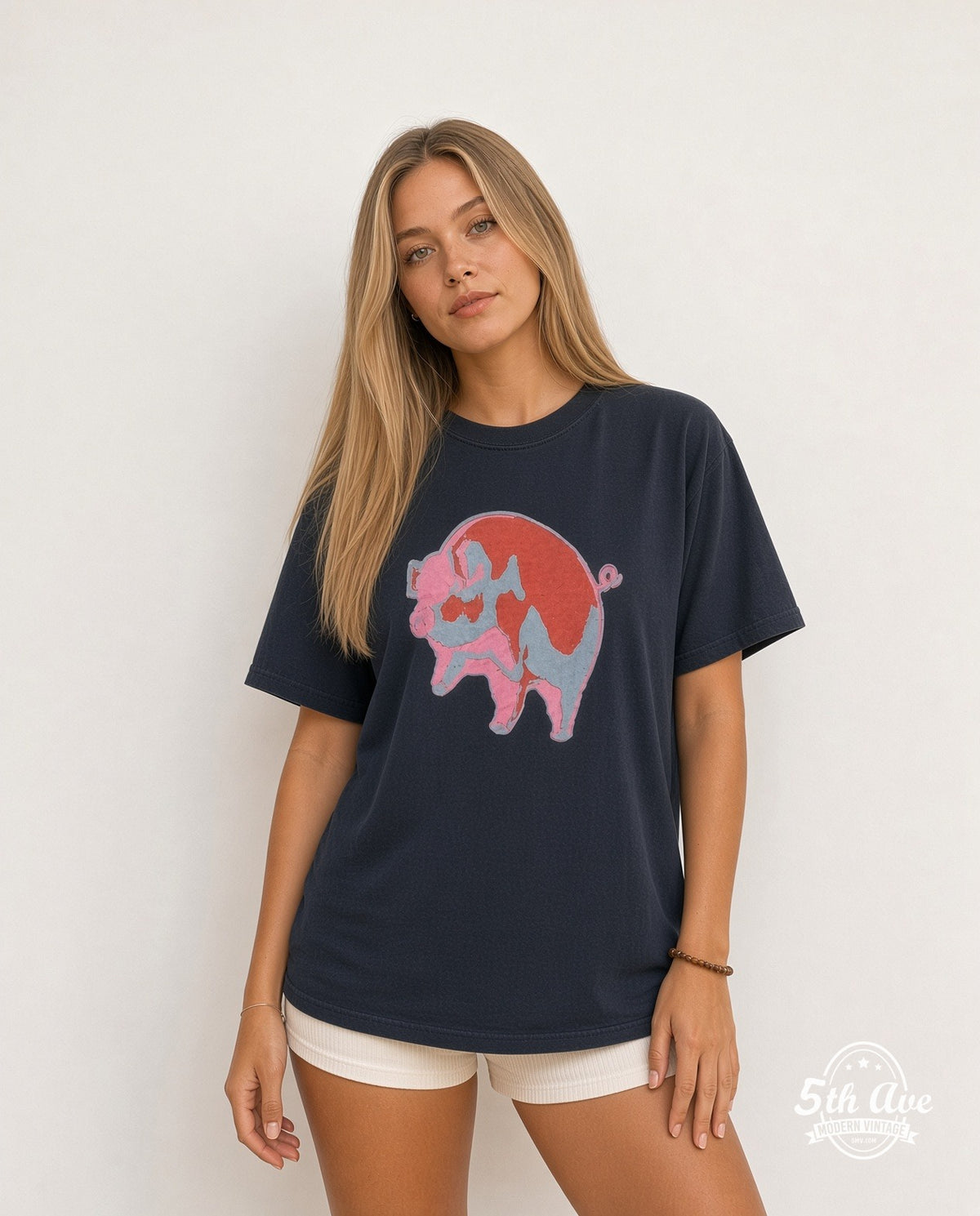 Model wearing the Pink Floyd Animals Red Pink Blue Pig vintage band t-shirt