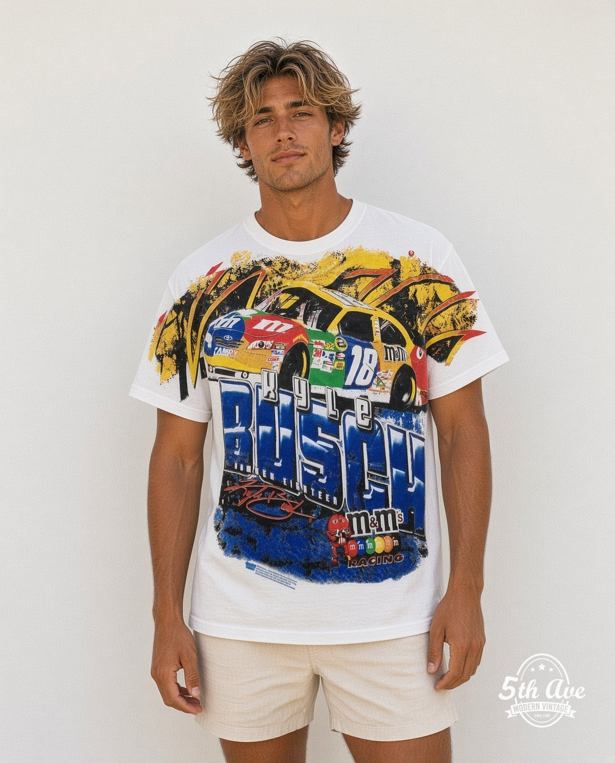Model wearing the NASCAR Kyle Busch #18 M&M's Block Name all-over-print NASCAR t-shirt in white