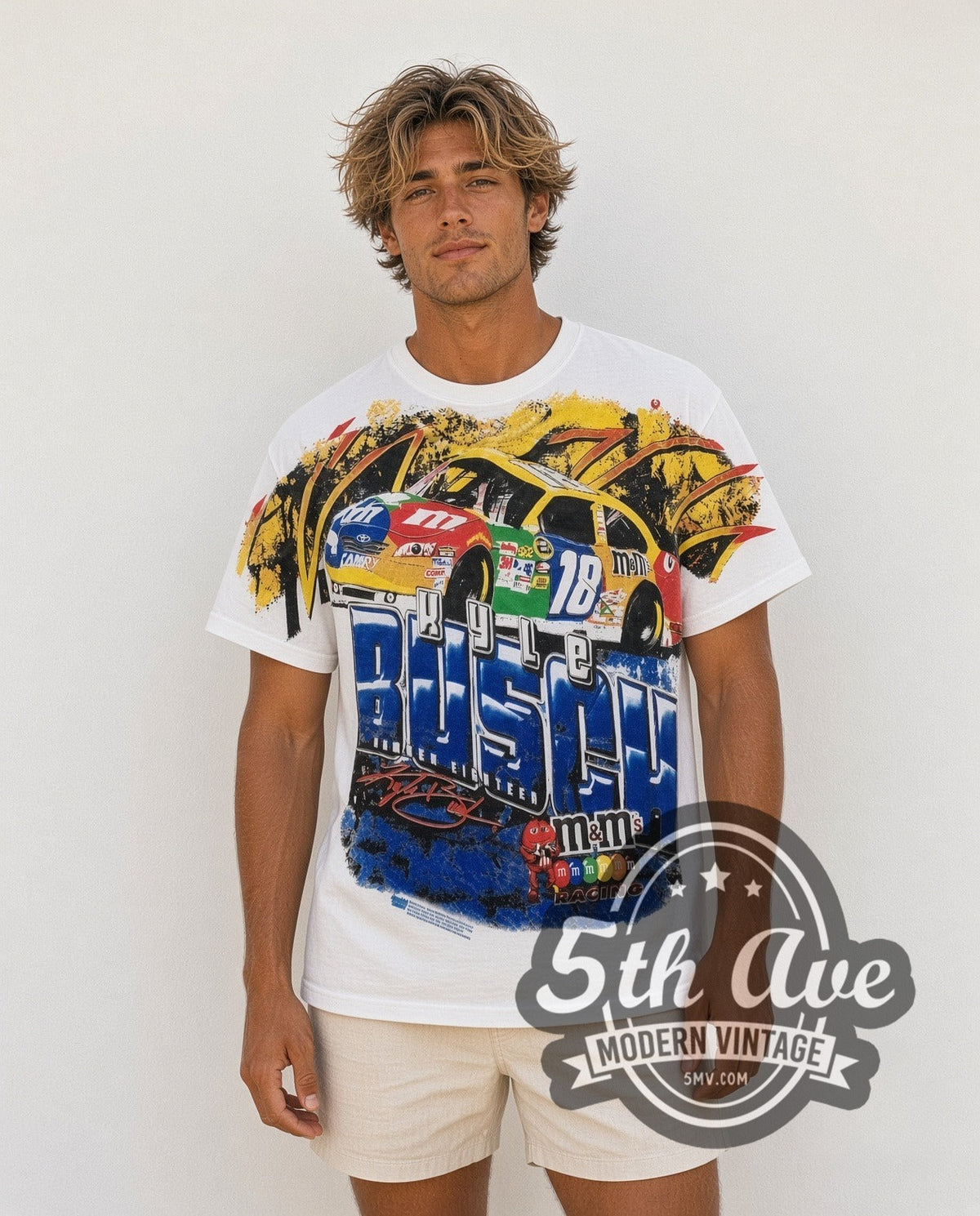 Model wearing the NASCAR Kyle Busch #18 M&M's Block Name all-over-print vintage NASCAR t-shirt in white