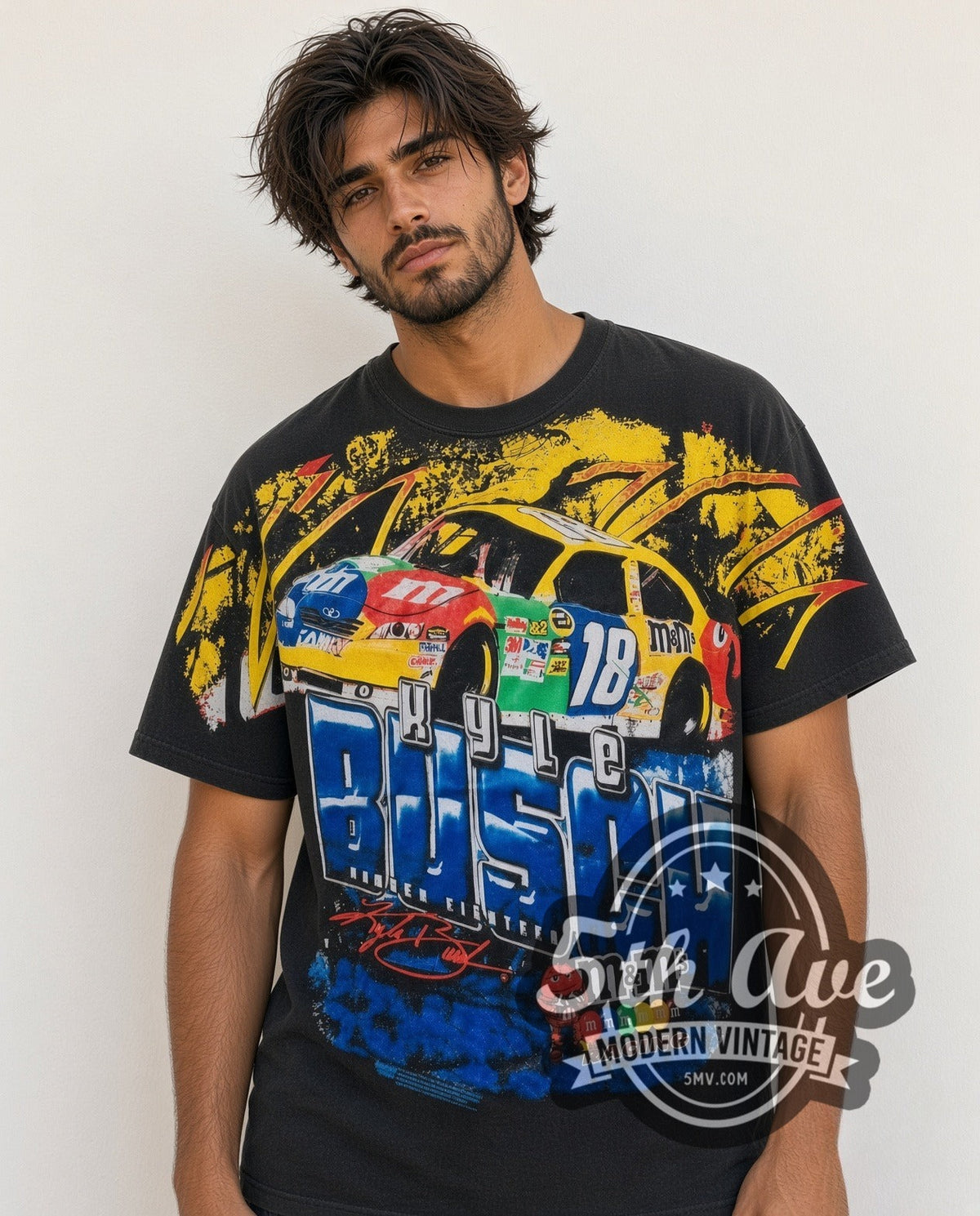 Model wearing the NASCAR Kyle Busch #18 M&M's Block Name all-over-print vintage NASCAR t-shirt in black