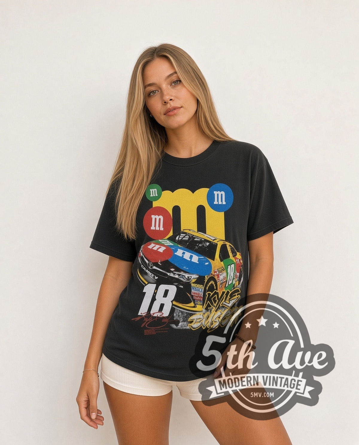Model wearing the NASCAR Kyle Busch #18 M&M's Characters all-over-print vintage NASCAR t-shirt in black