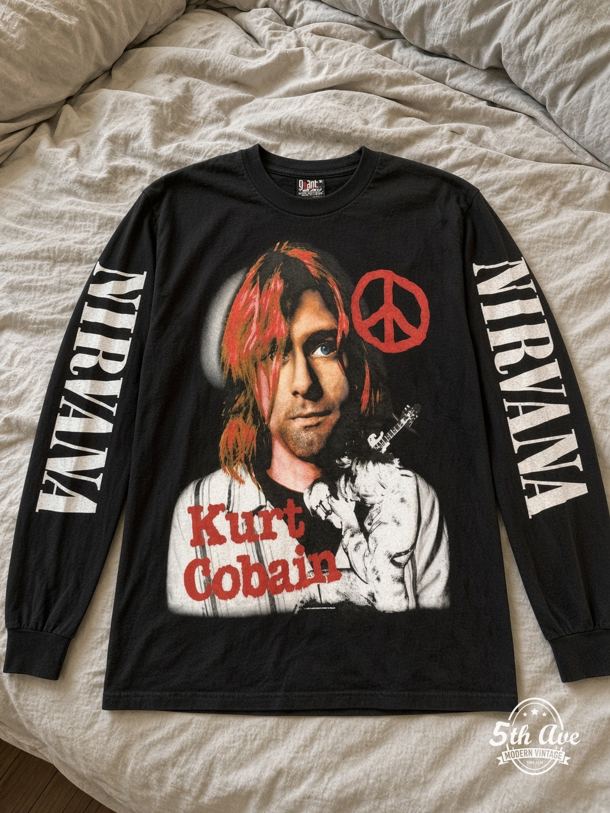 ETS LS 23 Nirvana Kurt Cobain Peace Sign long sleeve vintage tee laid on a bed