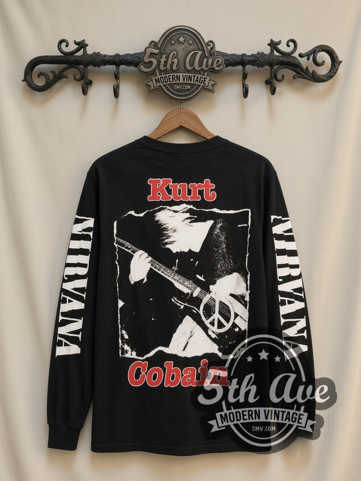Nirvana Kurt Cobain Peace Sign vintage band long sleeve t-shirt, back view on a display rack