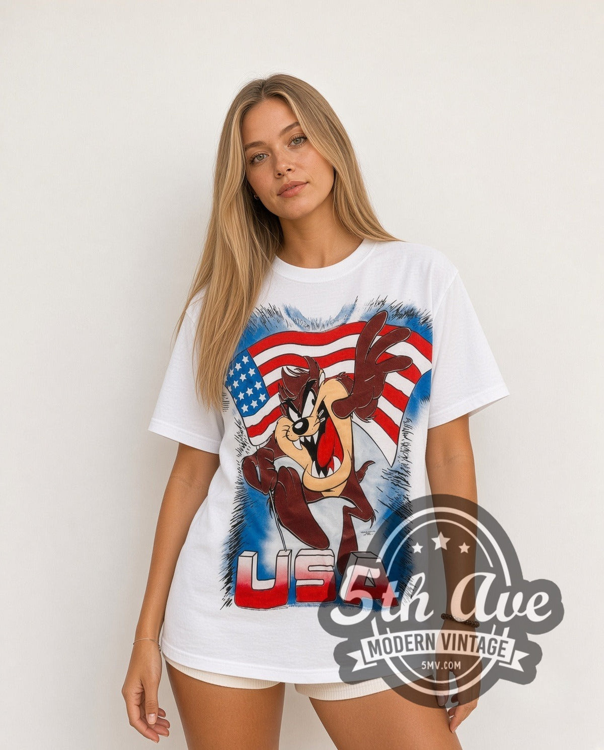 Model wearing the Looney Tunes Taz USA Flag all-over-print vintage cartoon t-shirt in white