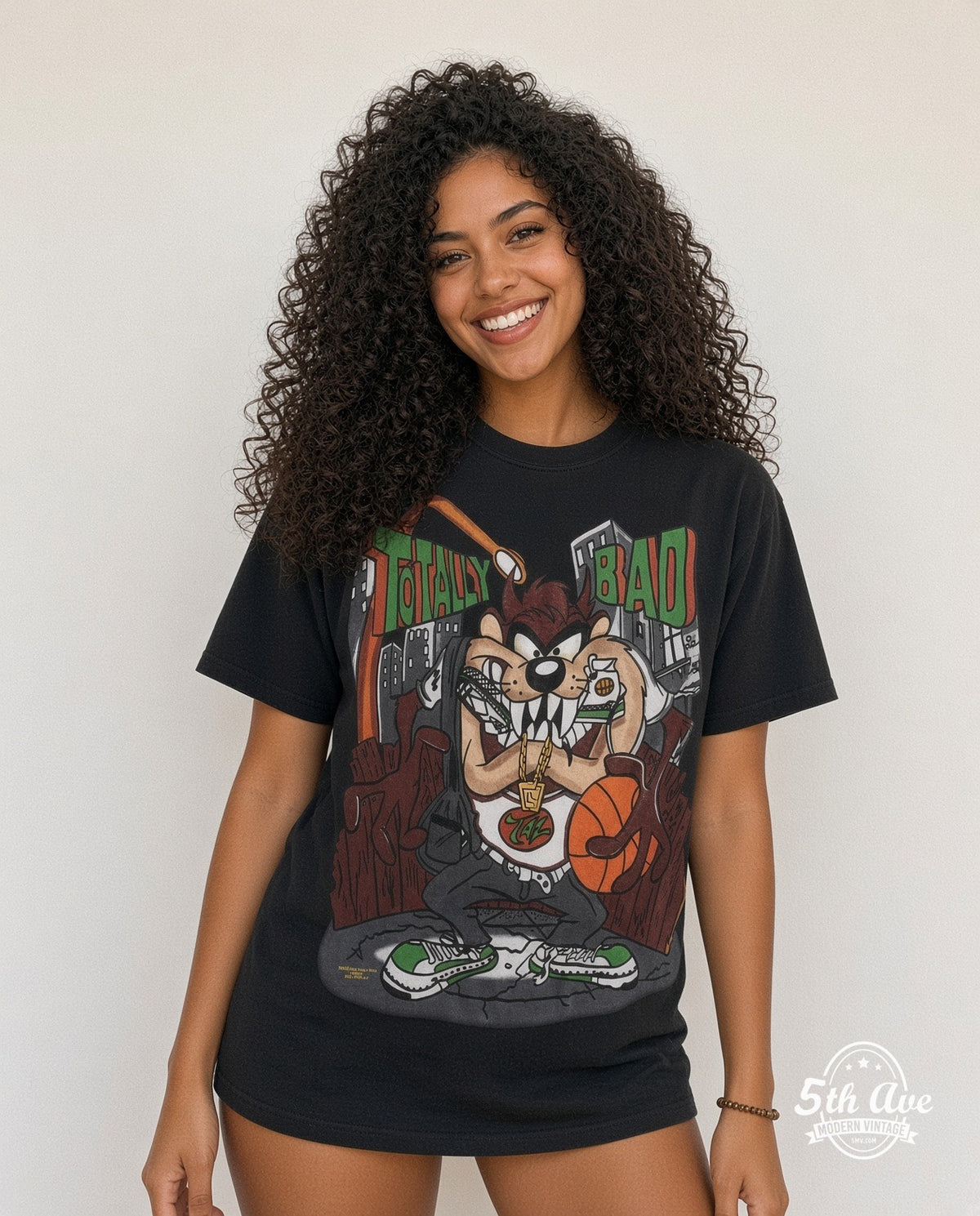 Model wearing the Looney Tunes Taz Totally Bad all-over-print cartoon t-shirt in black