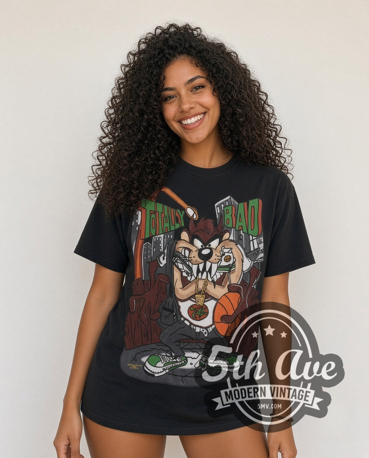 Model wearing the Looney Tunes Taz Totally Bad all-over-print vintage cartoon t-shirt in black