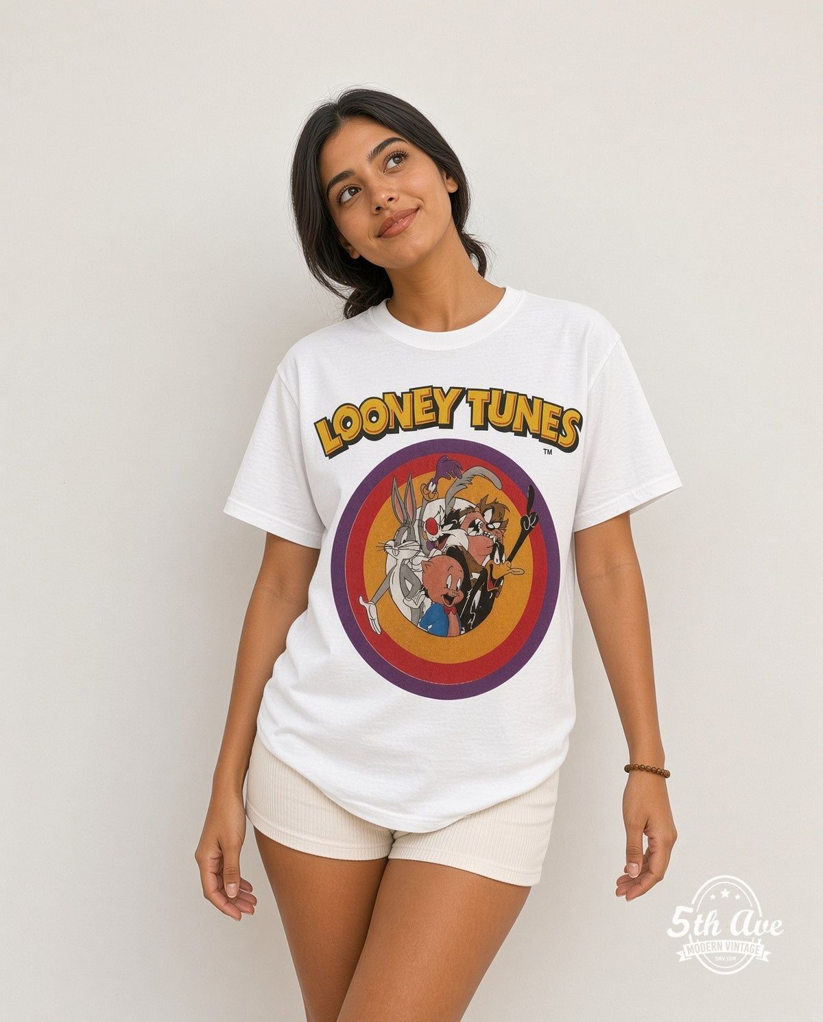 Model wearing the Looney Tunes Circle Badge Group all-over-print vintage cartoon t-shirt in white