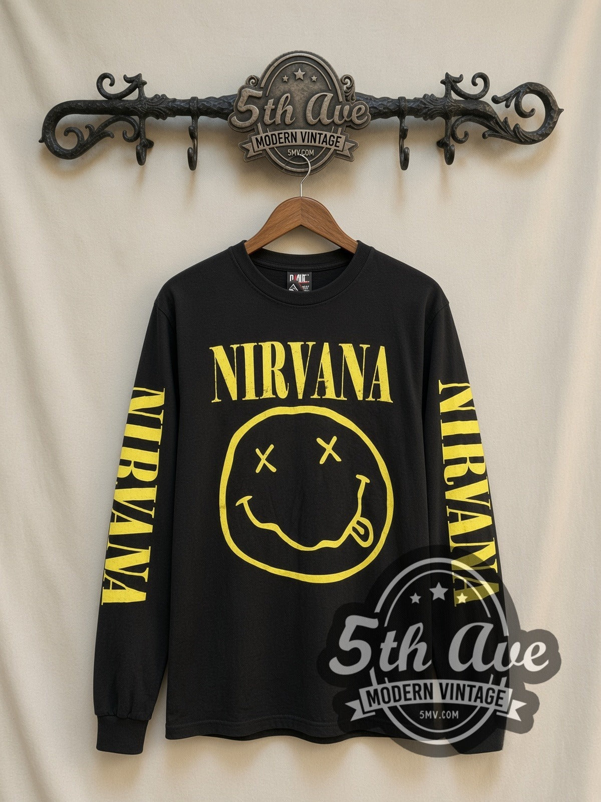 Nirvana Smiley Face vintage band long sleeve t-shirt, front view on a display rack