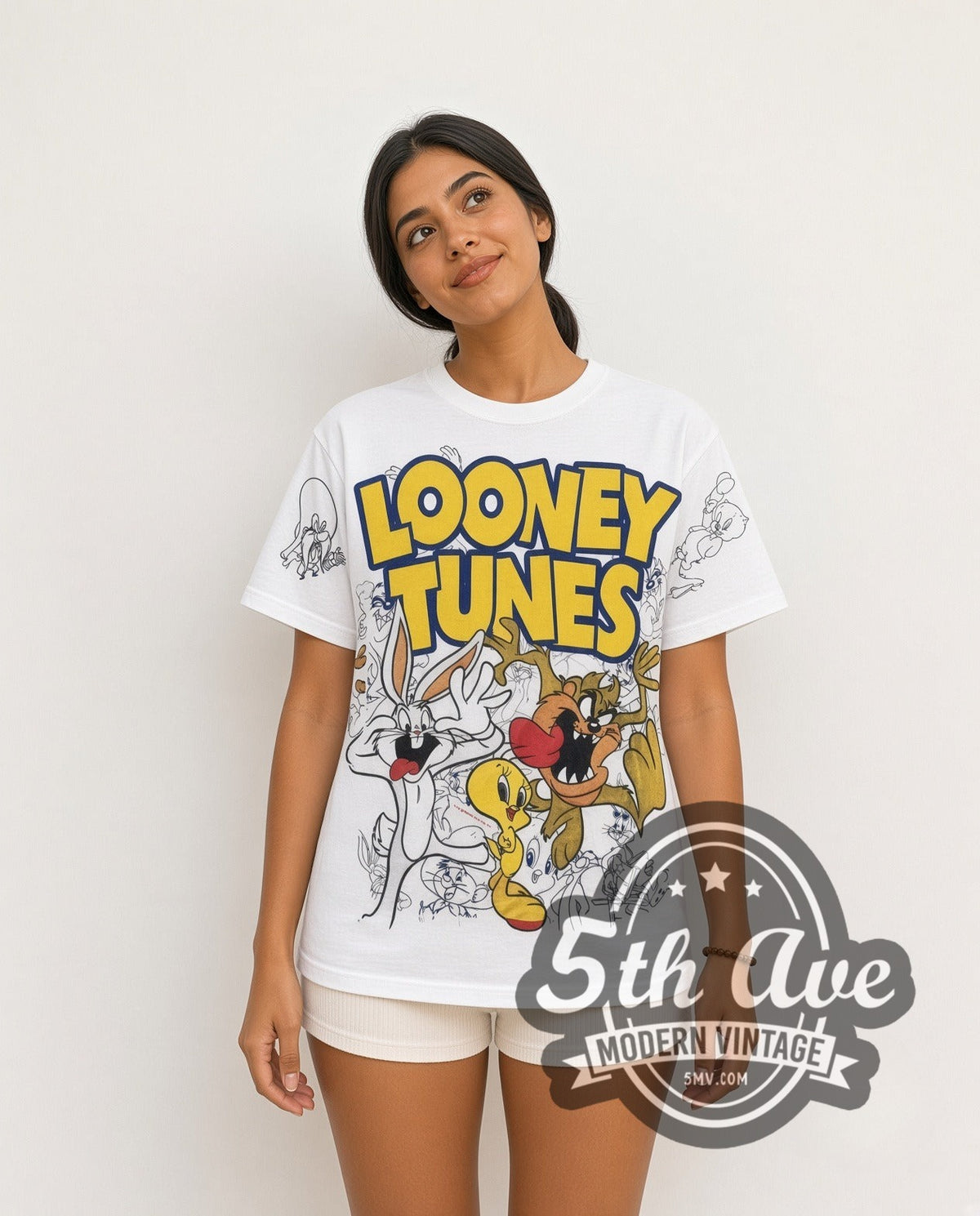 Model wearing the Looney Tunes Logo Bugs Tweety Taz Crew all-over-print vintage cartoon t-shirt in white