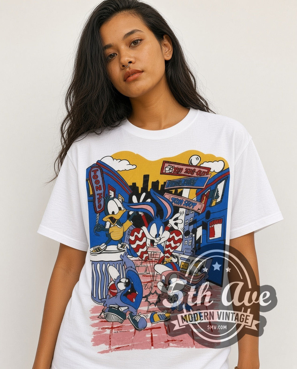Model wearing the Tiny Toon Adventures Toon Town Crew all-over-print vintage cartoon t-shirt in white
