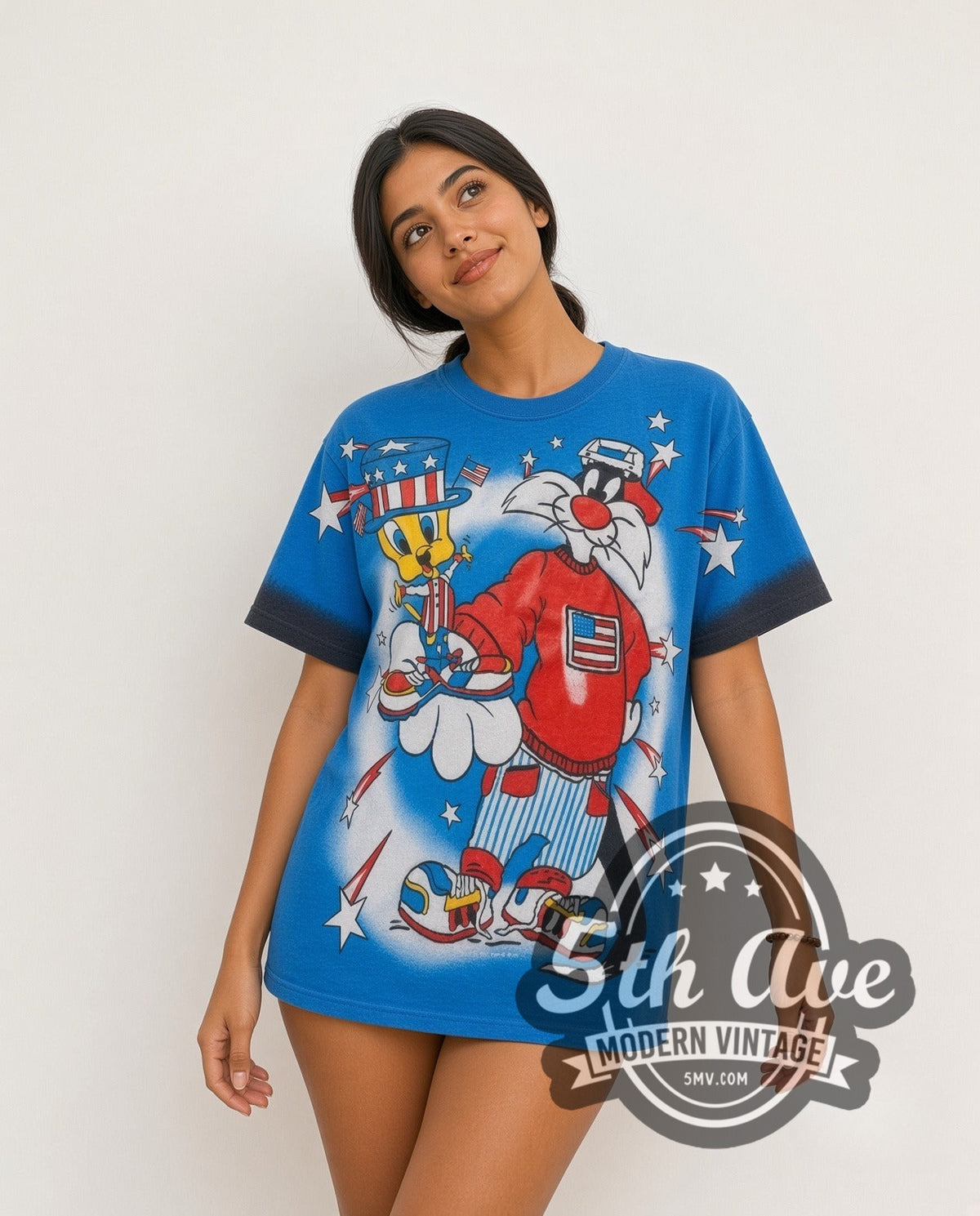 Model wearing the Looney Tunes Sylvester Uncle Sam Patriotic all-over-print vintage cartoon t-shirt in blue