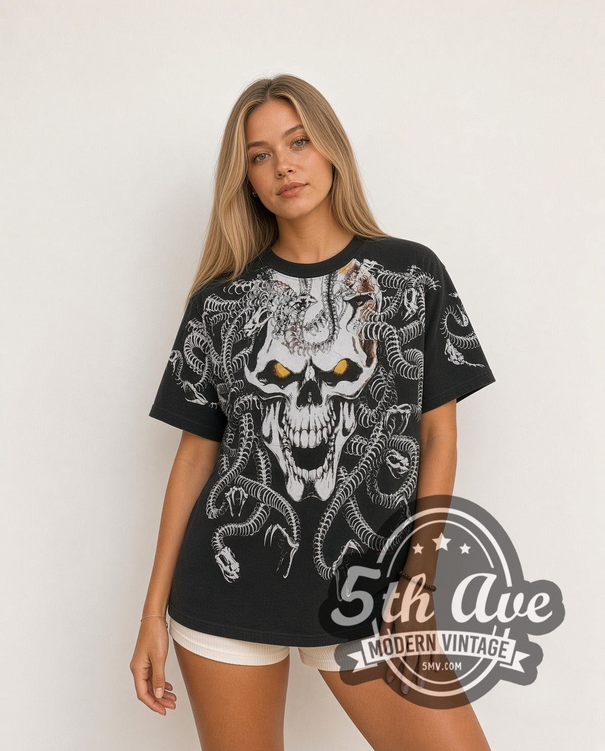 Model wearing the Medusa Snake Skull all-over-print vintage graphic tee in black