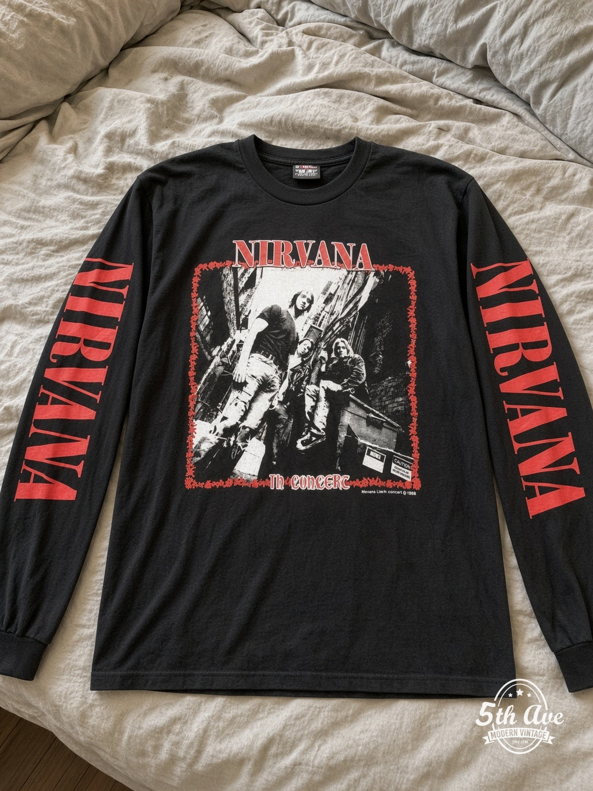 ETS LS 57 Nirvana In Concert long sleeve vintage tee laid on a bed