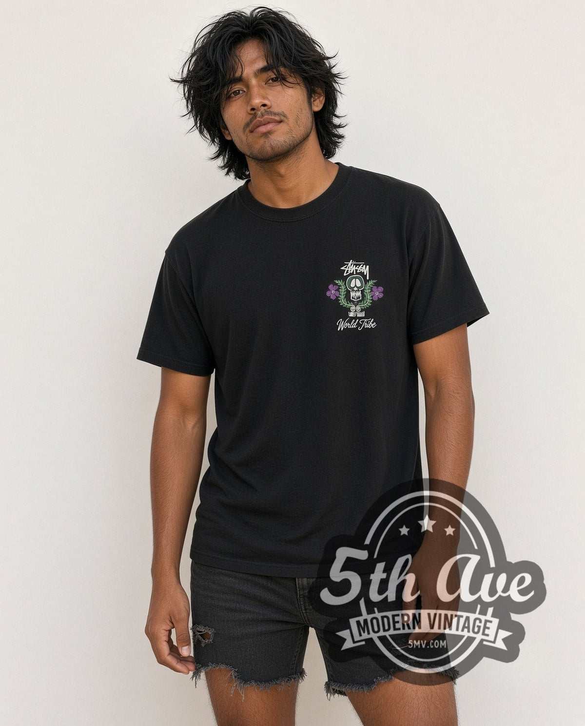Model wearing the Stussy World Tribe Skull Crest vintage graphic tee in black