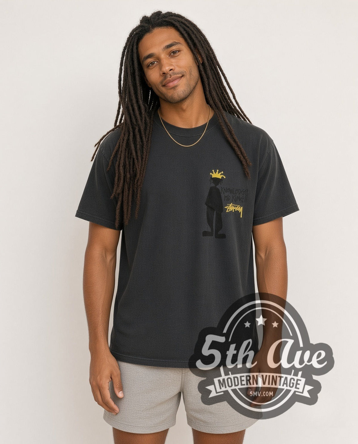 Model wearing the Stussy Knowledge Is King vintage graphic tee in black