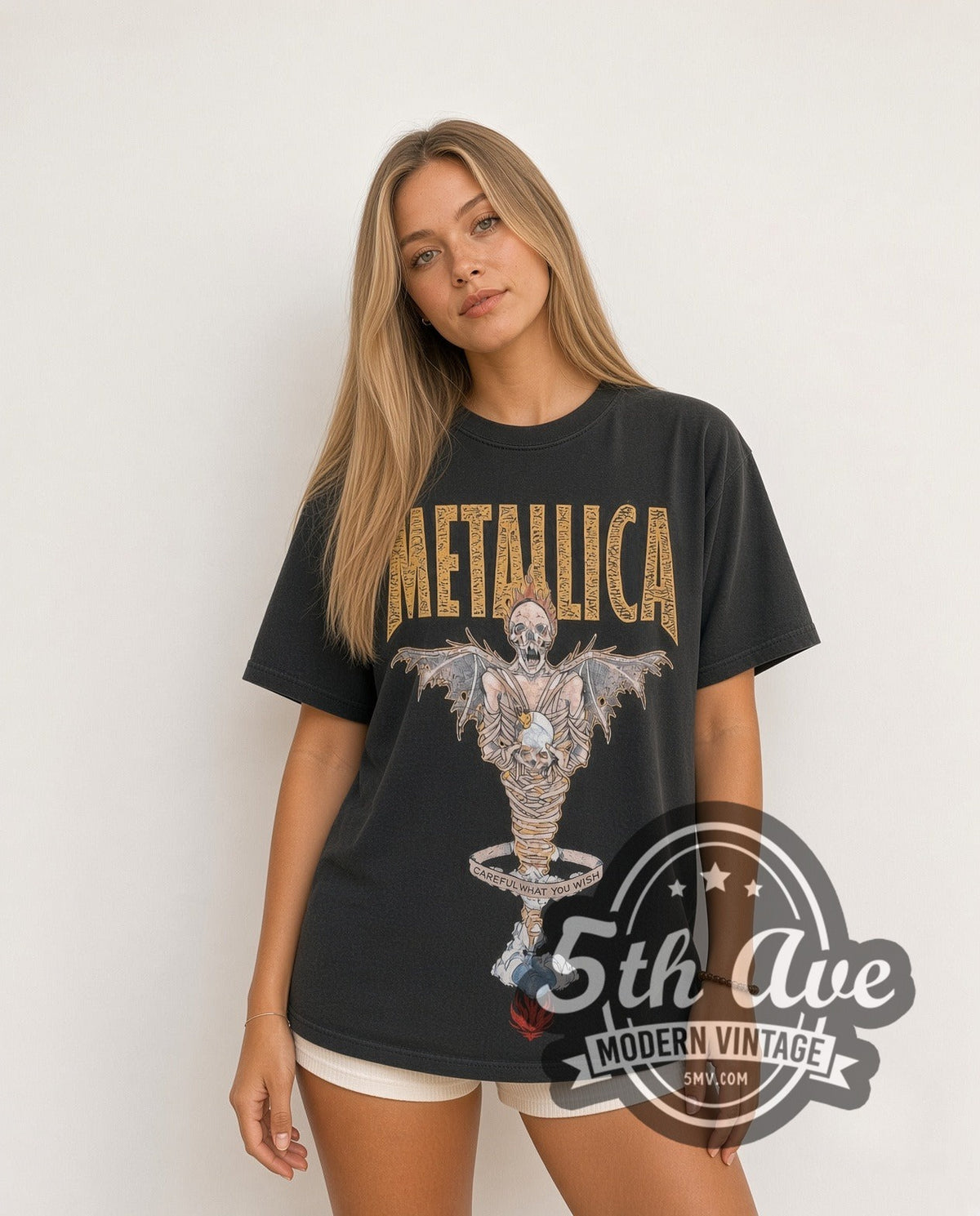 Model wearing the Metallica King Nothing Careful What You Wish Winged Skeleton vintage band t-shirt in black