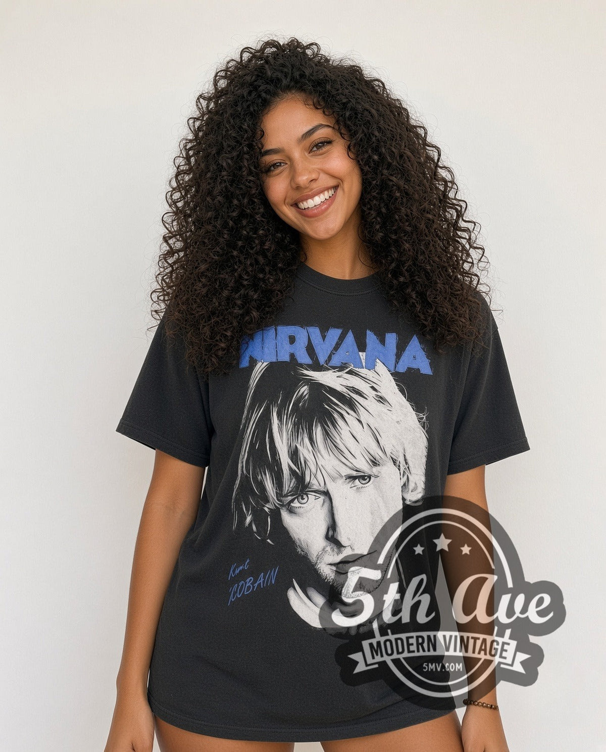 Model wearing the Nirvana Kurt Cobain Blue Logo Play Electric Guitar vintage band t-shirt in black