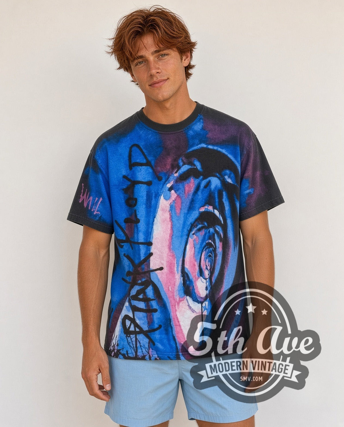 Model wearing the Pink Floyd The Wall Pink Blue Screaming Face all-over-print vintage band t-shirt in black