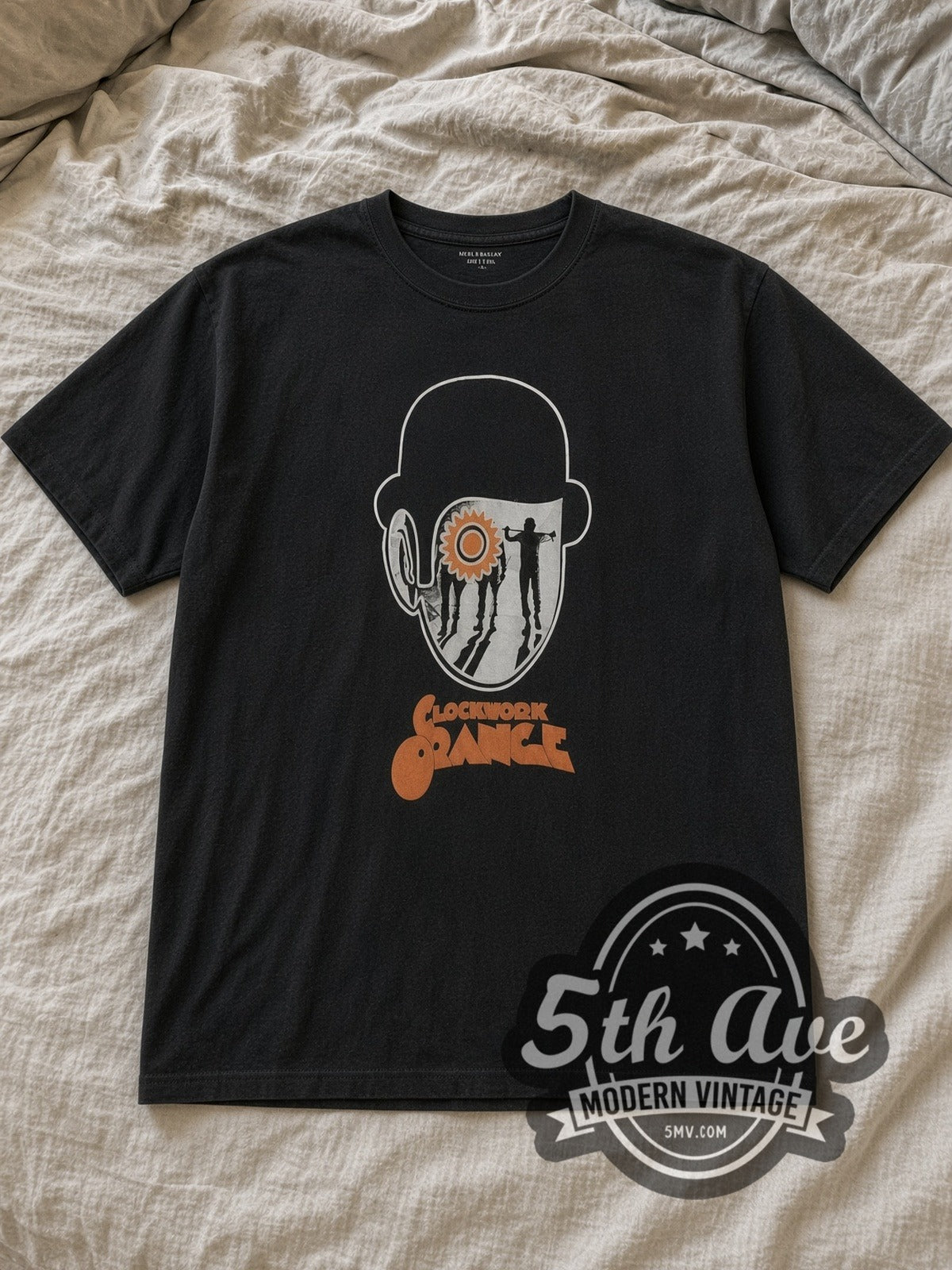 Black A Clockwork Orange Bowler Hat Cog Eye Droogs Poster Vintage Movie T-Shirt laid flat on a linen bed