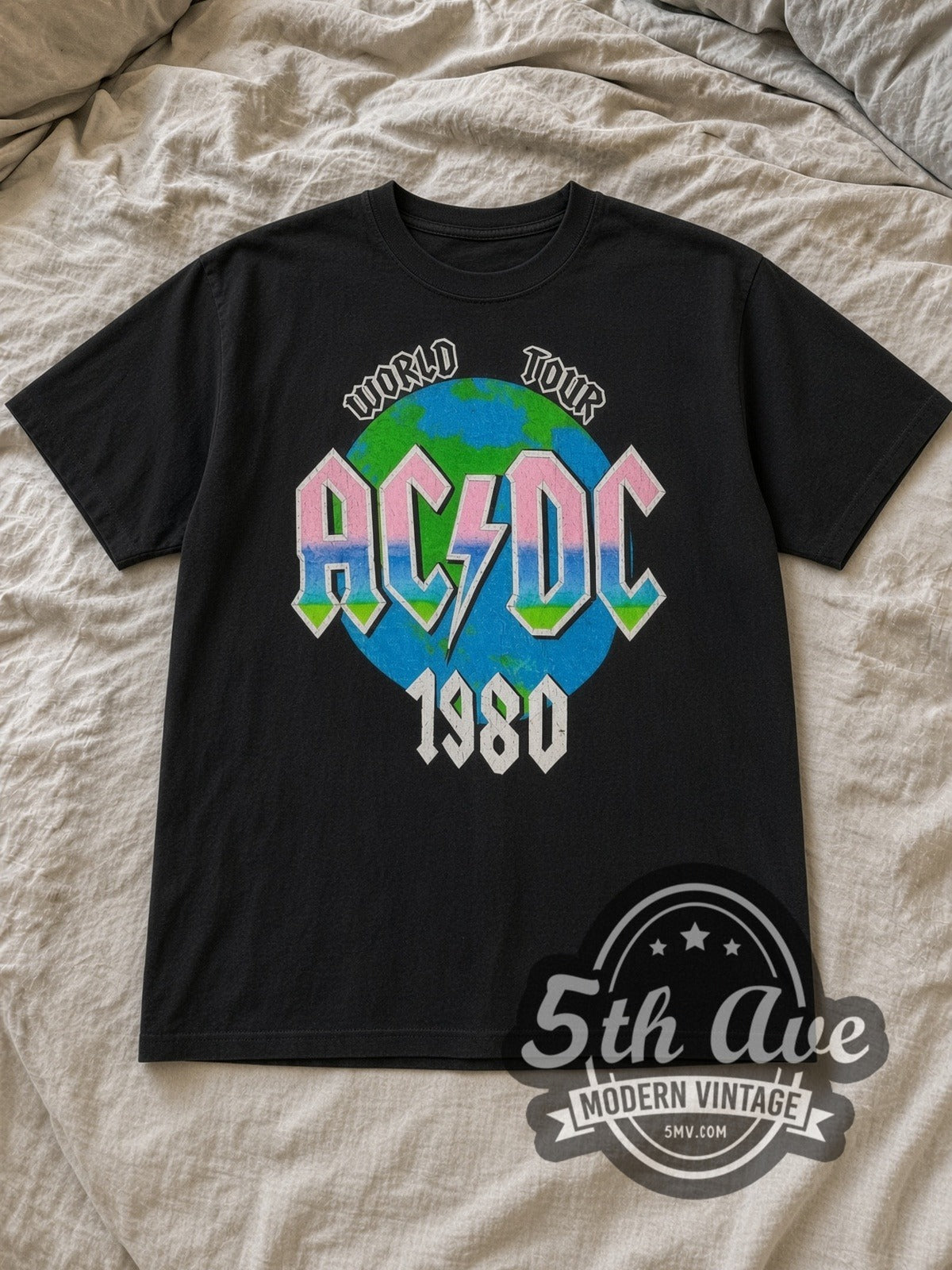 Black AC/DC Back in Black World Tour 1980 Vintage Band T-Shirt laid flat on a linen bed