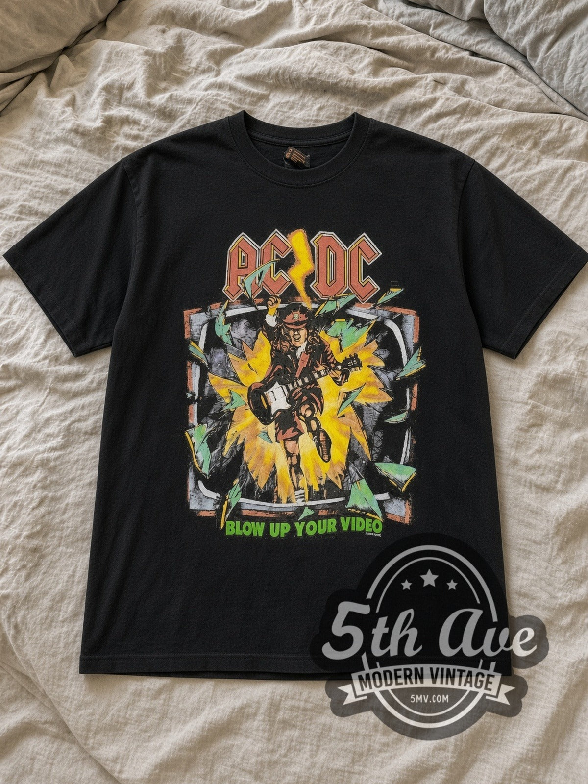 Black AC/DC Blow Up Your Video TV Burst City List Vintage Band T-Shirt laid flat on a linen bed