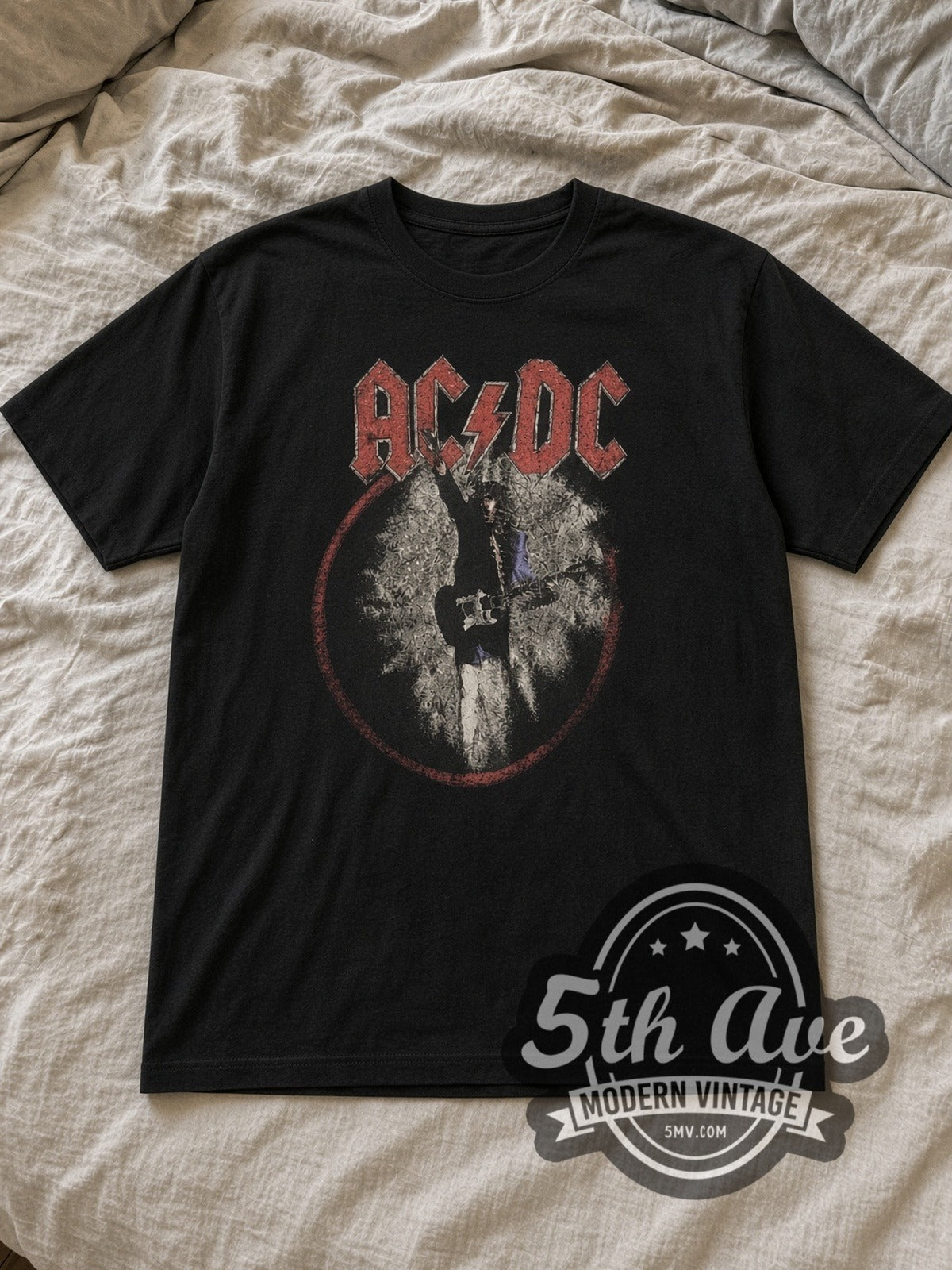 Black AC/DC 1988 World Tour Vintage Band T-Shirt laid flat on a linen bed
