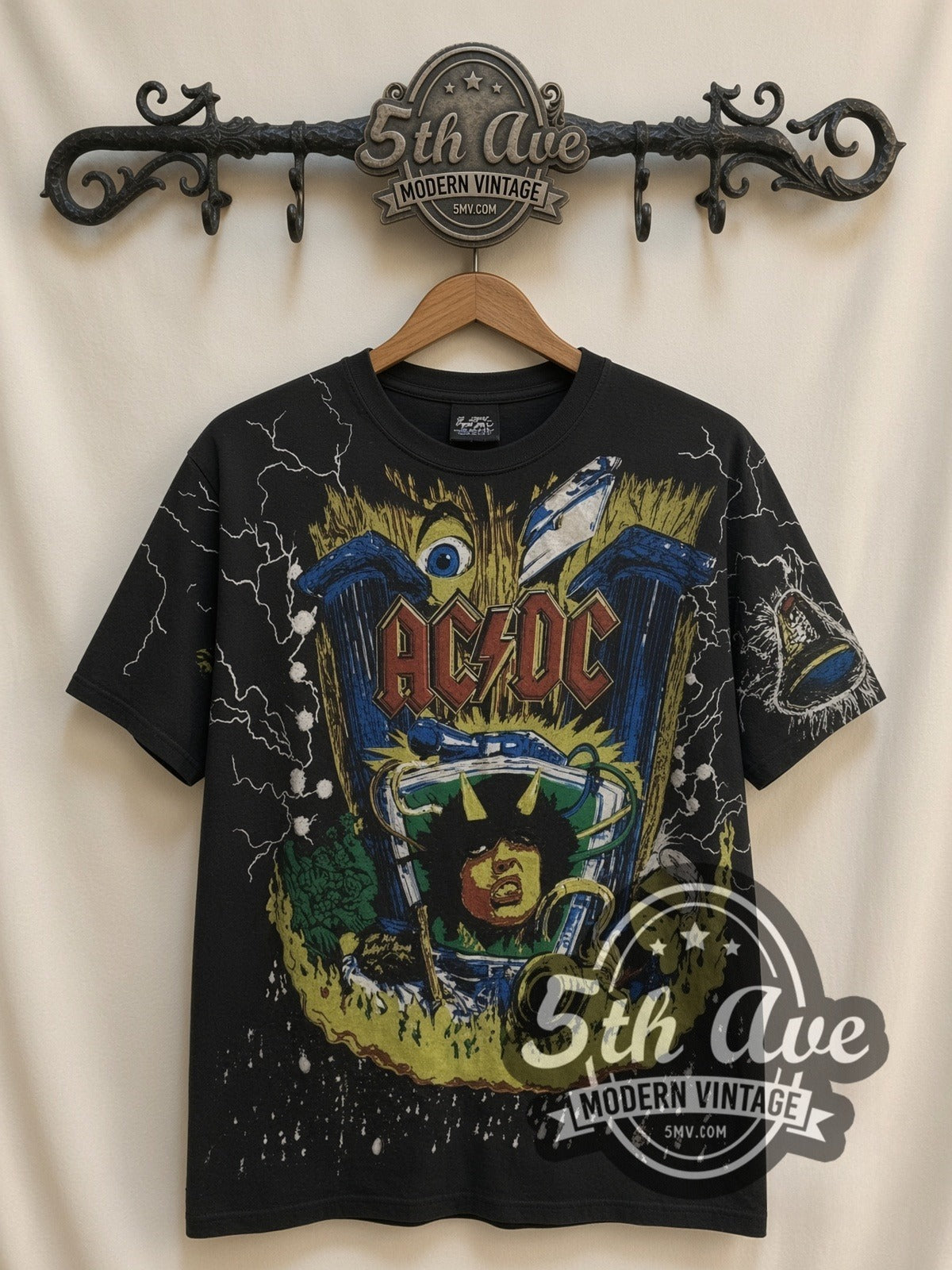 AC/DC Angus V Graphic all-over-print vintage band t-shirt in black, front view on a display rack