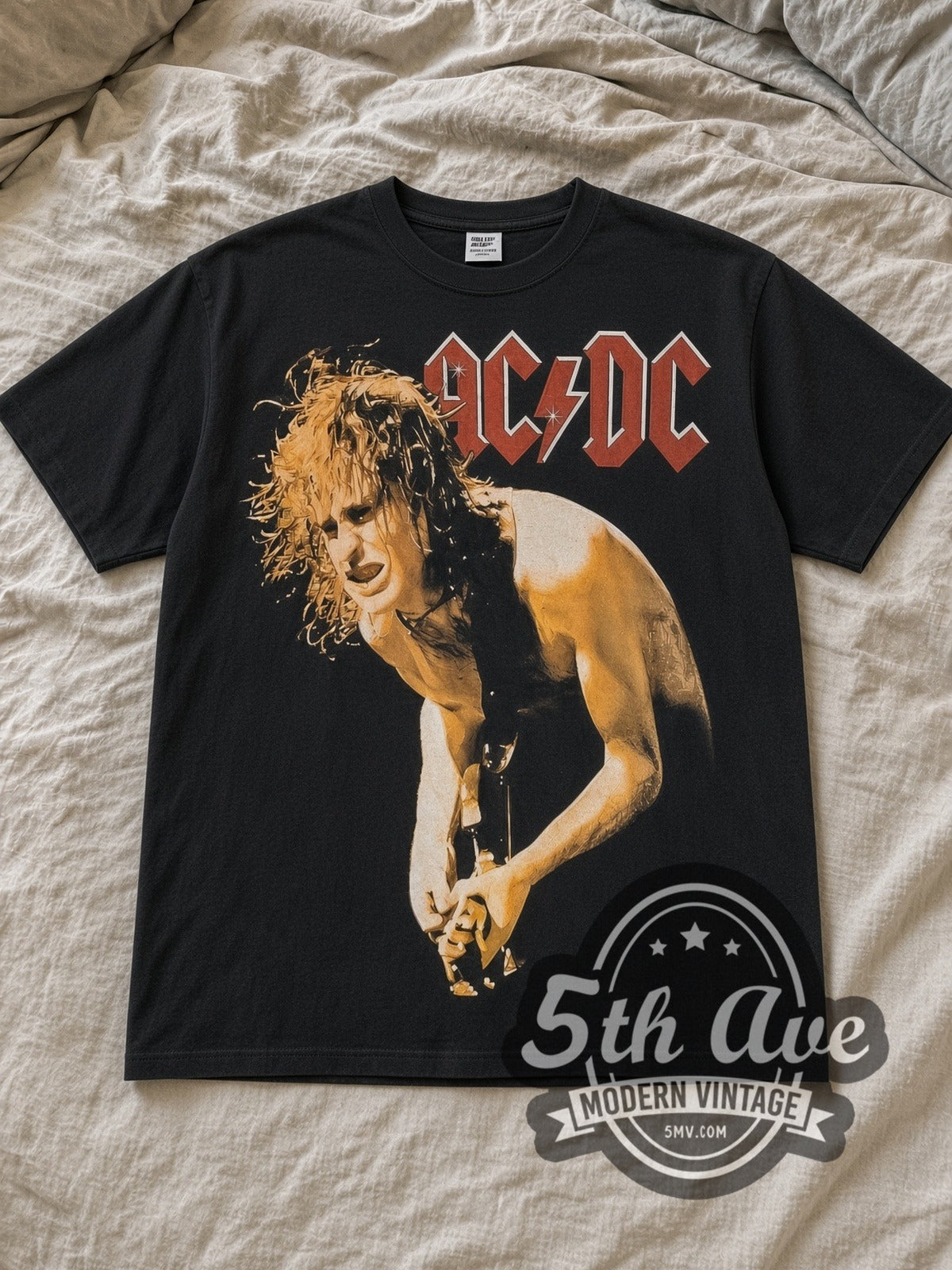 Black AC/DC Angus Young Guitar Solo All Over Print Vintage Band T-Shirt laid flat on a linen bed