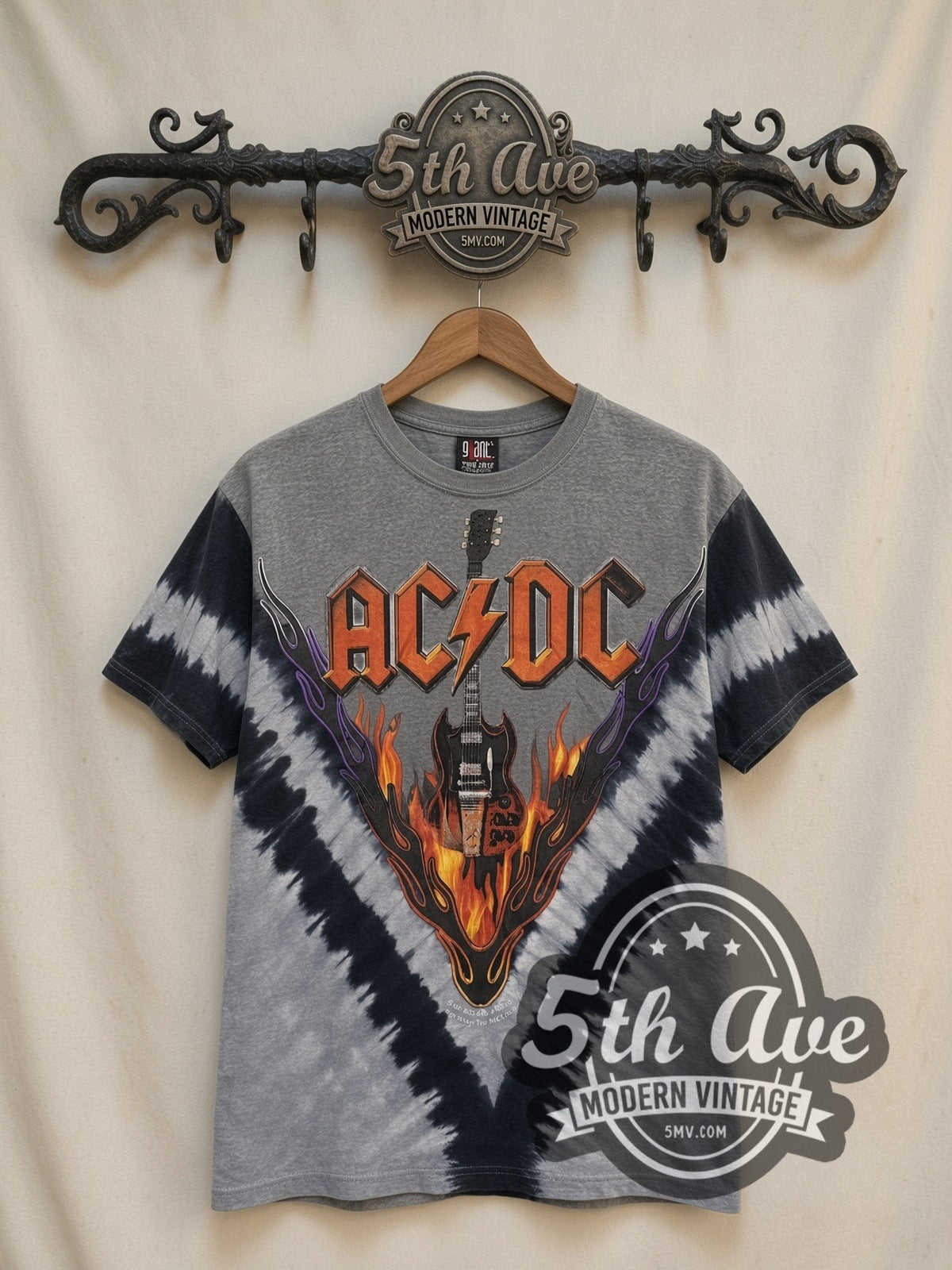 AC/DC Flaming Winged Guitar Tie-Dye V Grey all-over-print vintage band t-shirt, front view on a display rack