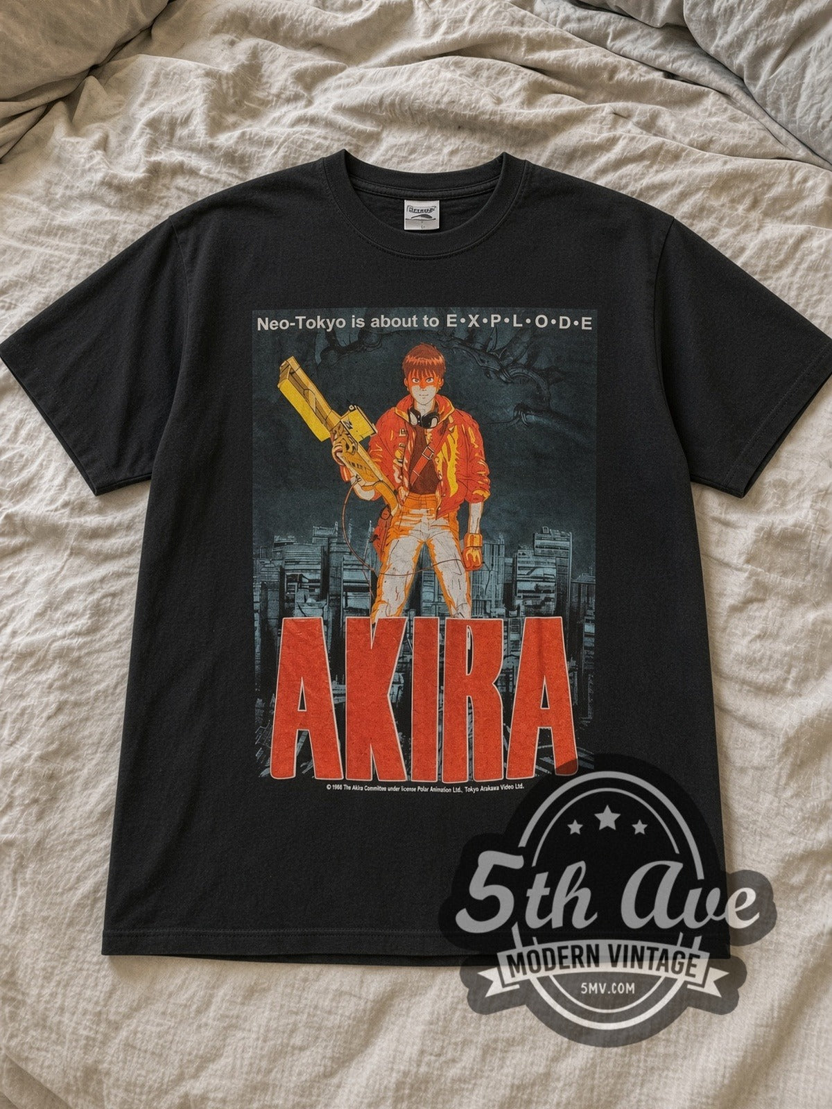 Black Akira Neo Tokyo Is About to Explode Vintage Anime T-Shirt laid flat on a linen bed