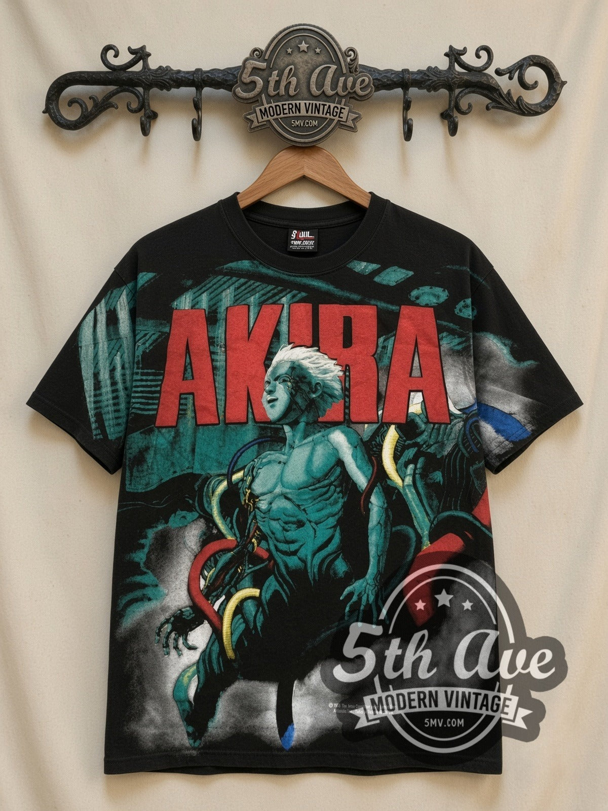 Akira Teal Character all-over-print graphic tee in black, front view on a display rack