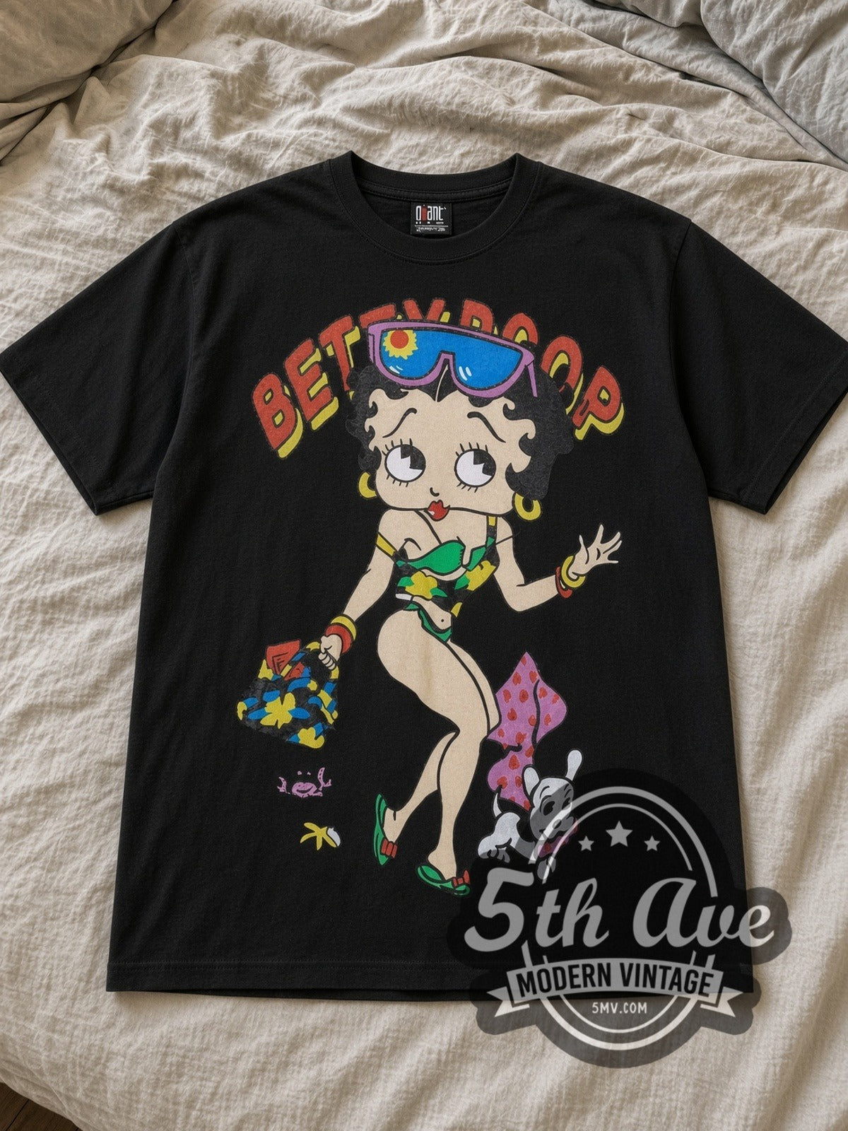 Black Betty Boop Beach Vibes Vintage Cartoon T-Shirt laid flat on a linen bed
