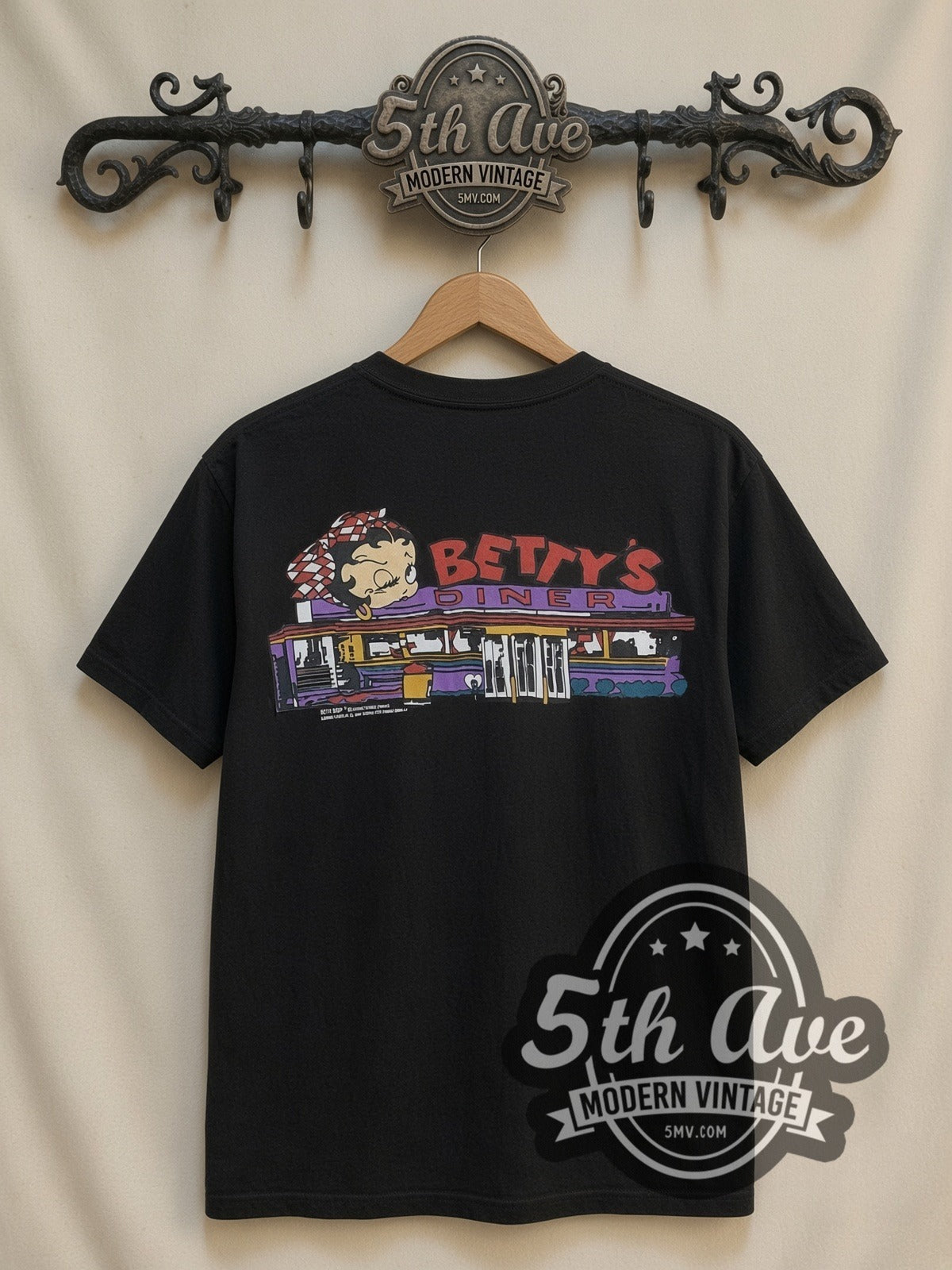 Betty Boop Checkered Dress Abstract all-over-print vintage cartoon t-shirt in black, back view on a display rack