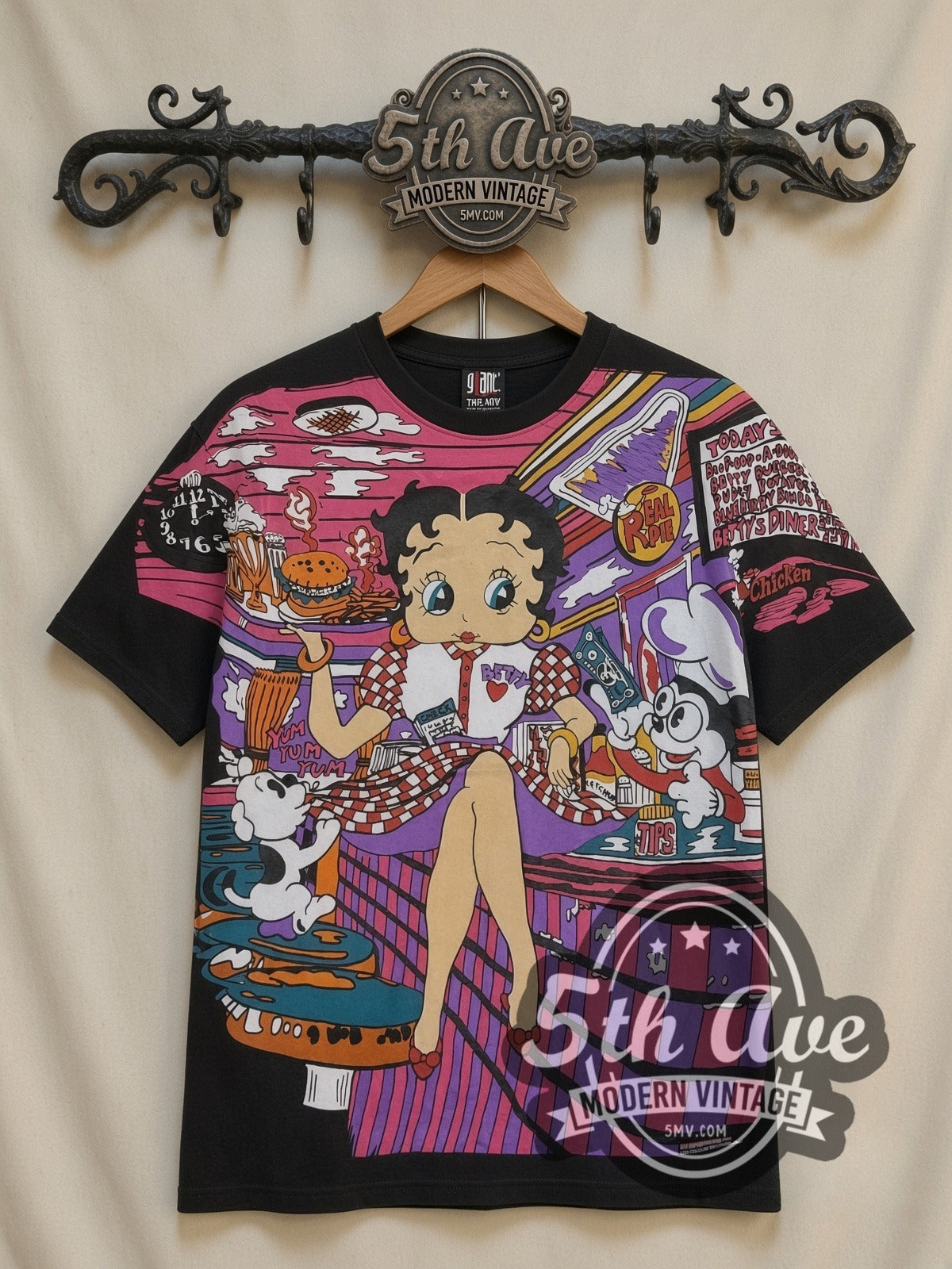 Betty Boop Checkered Dress Abstract all-over-print vintage cartoon t-shirt in black, front view on a display rack
