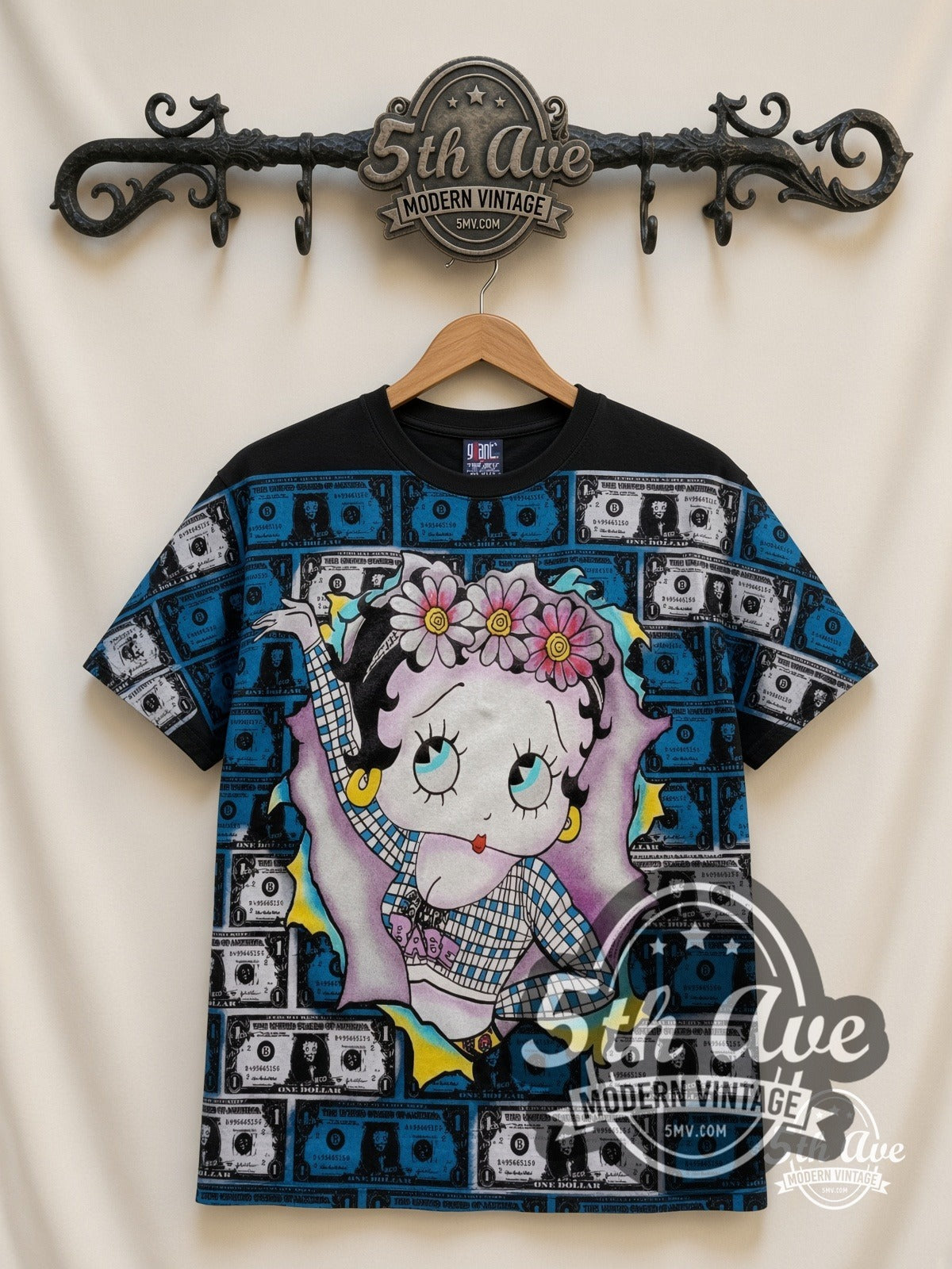 Betty Boop Hundred Dollar Bills all-over-print vintage cartoon t-shirt in black, front view on a display rack