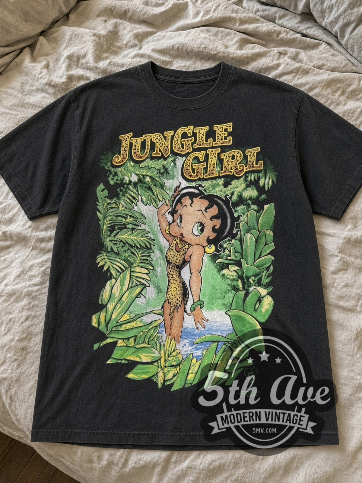 Black Betty Boop Jungle Girl tee laid flat on linen bed
