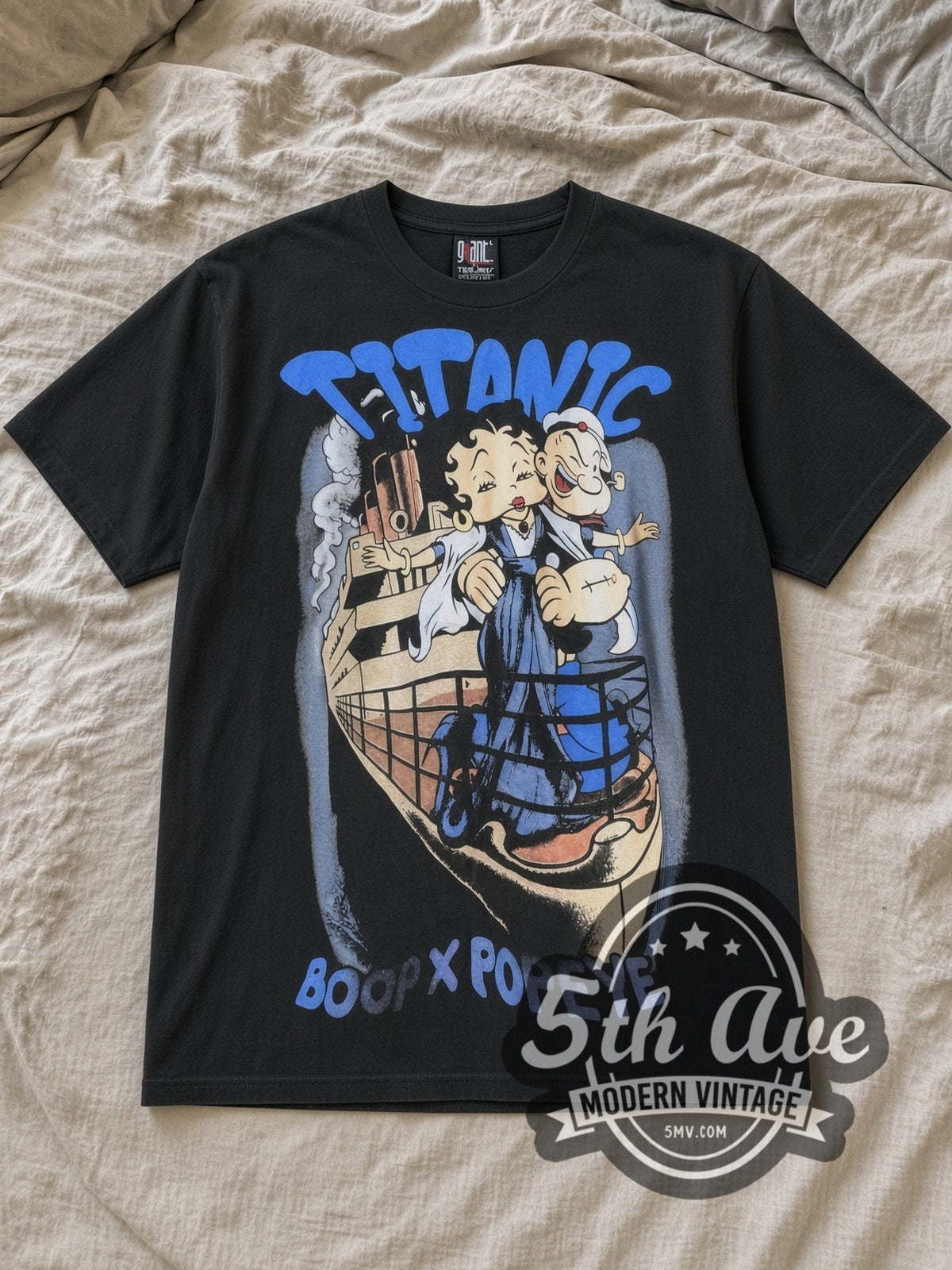 Black Betty Boop Betty Boop, Popeye and Titanic Vintage Cartoon T-Shirt laid flat on a linen bed