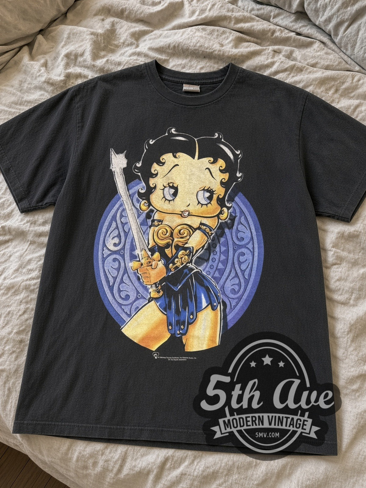 Black Betty Boop Warrior Boop tee laid flat on linen bed