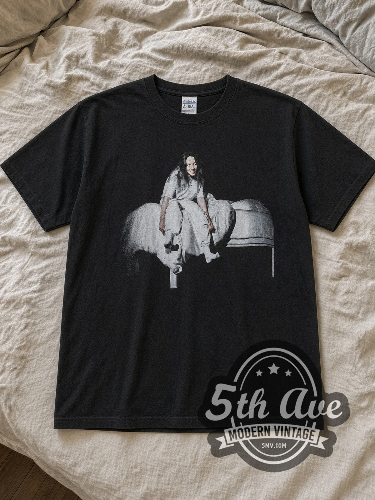 Black Billie Eilish Vintage Band T-Shirt laid flat on a linen bed