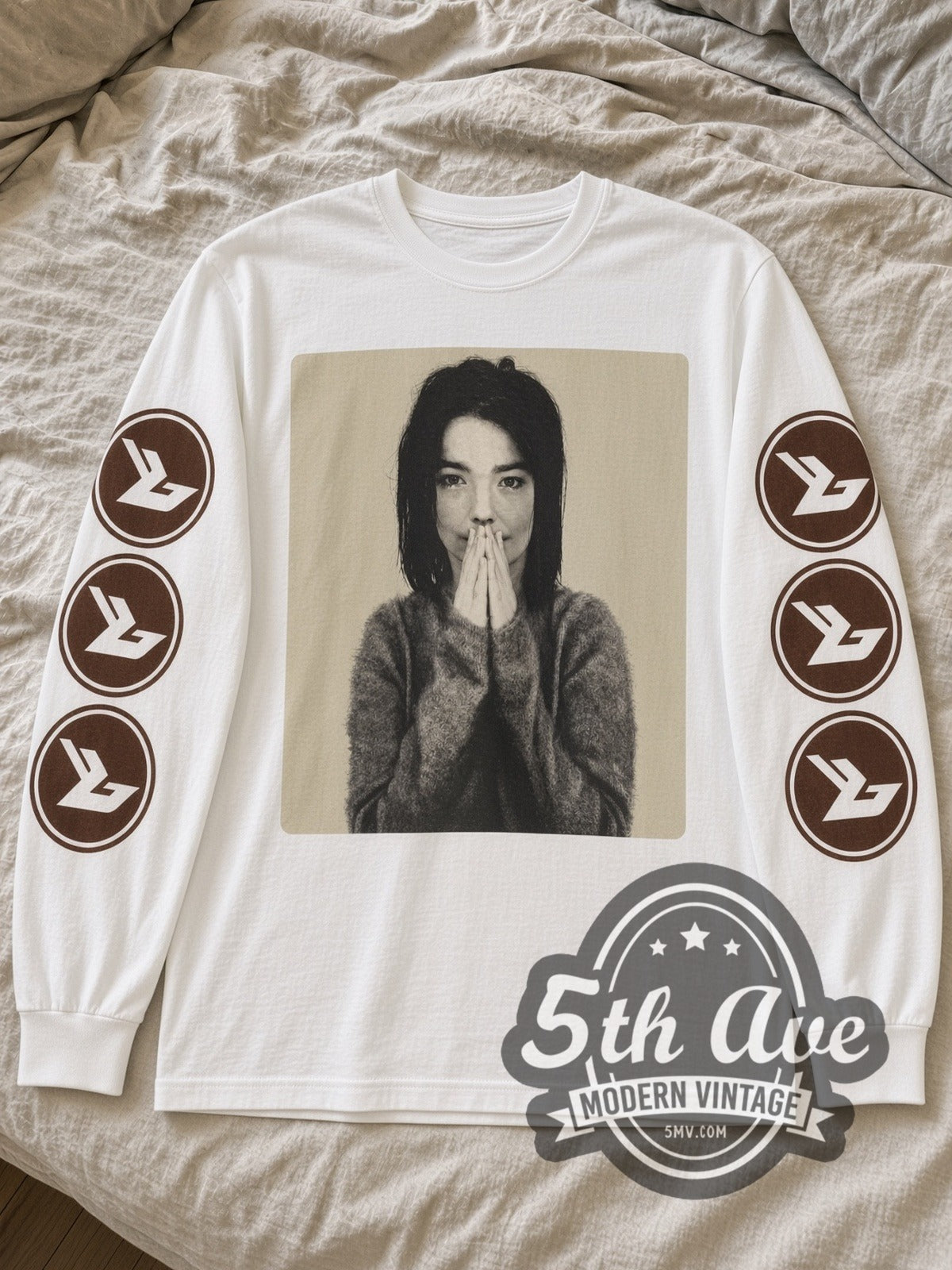 White Björk Debut long sleeve tee laid flat on linen bed